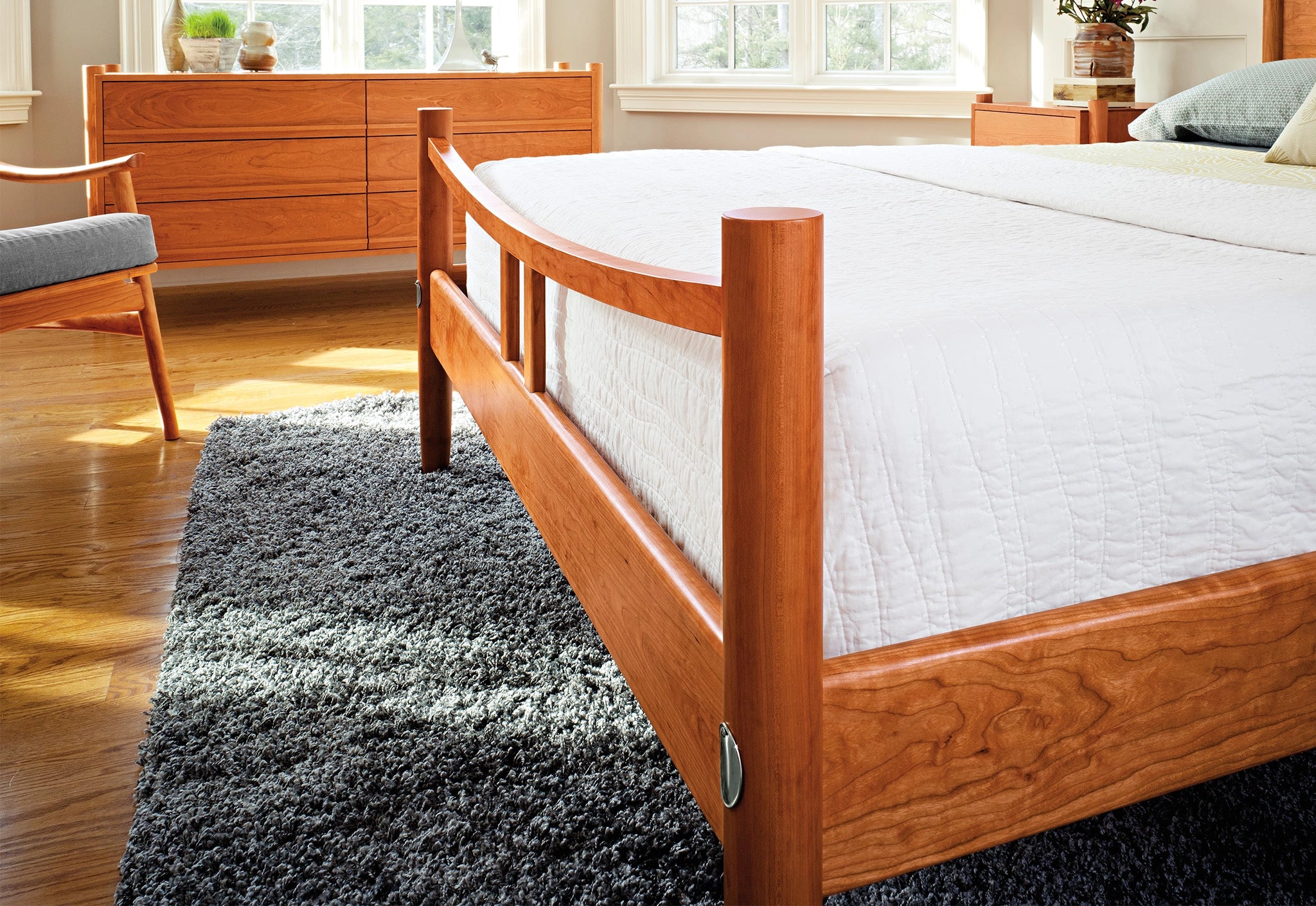 Wooden bed frame with white mattress in a bedroom setting