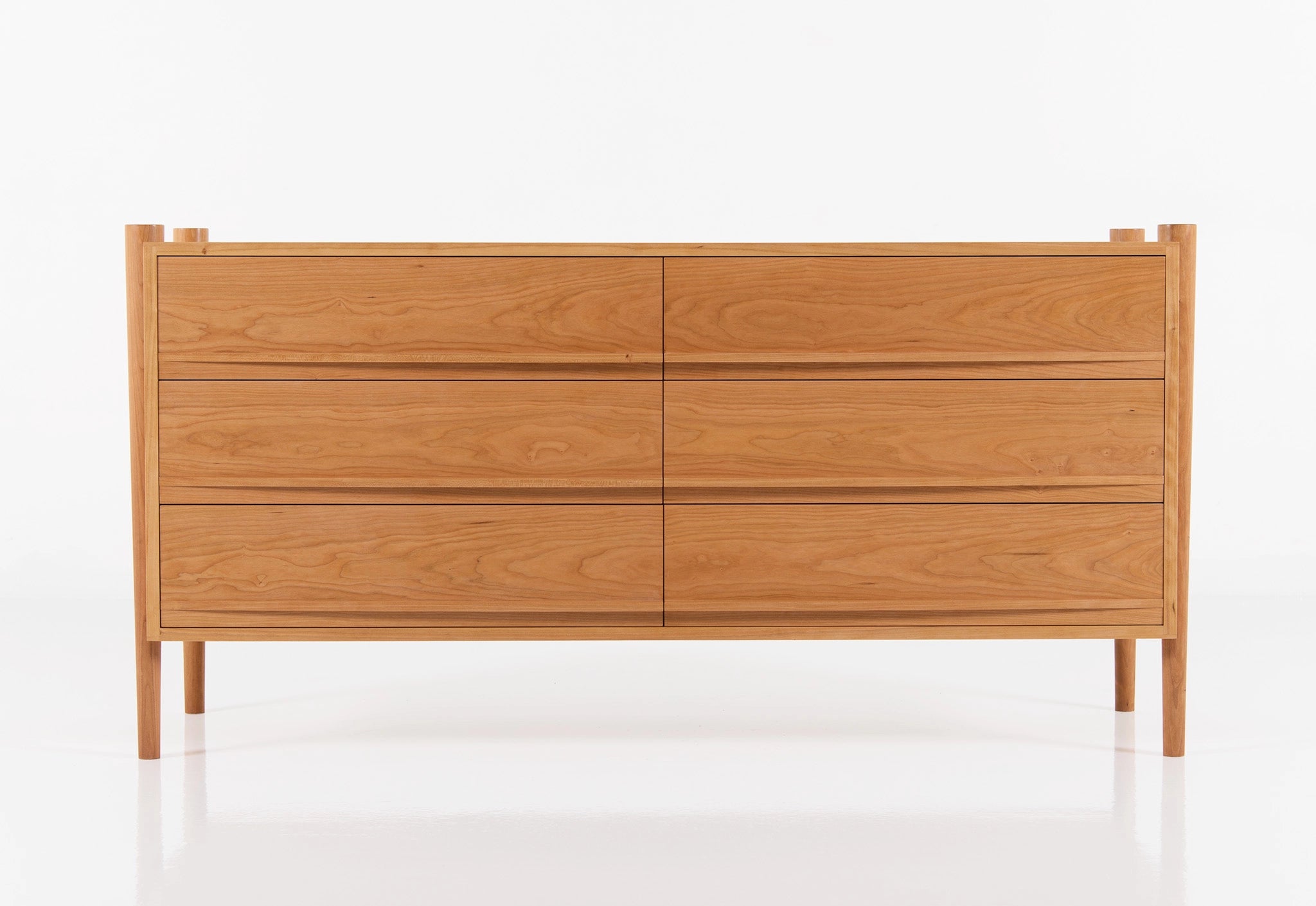 Wooden dresser with six drawers on a white background