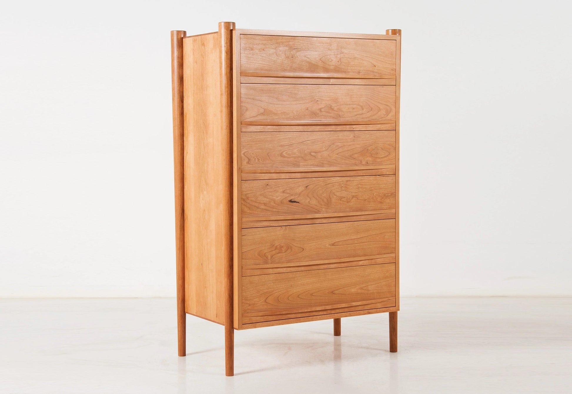 Wooden cabinet with multiple drawers on a white background