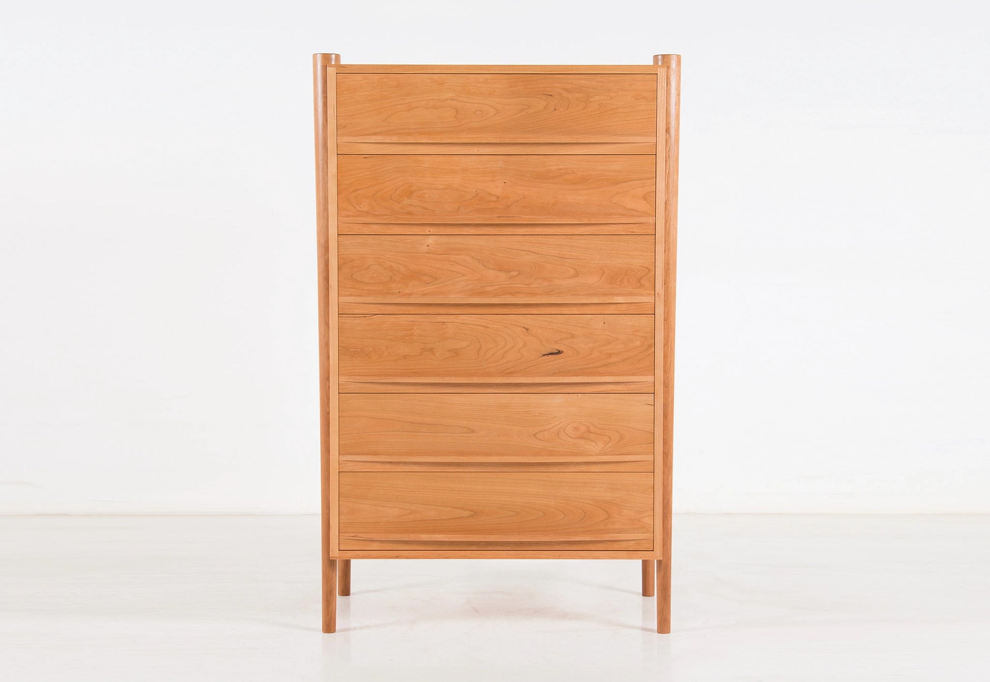 Wooden dresser with multiple drawers on a white background