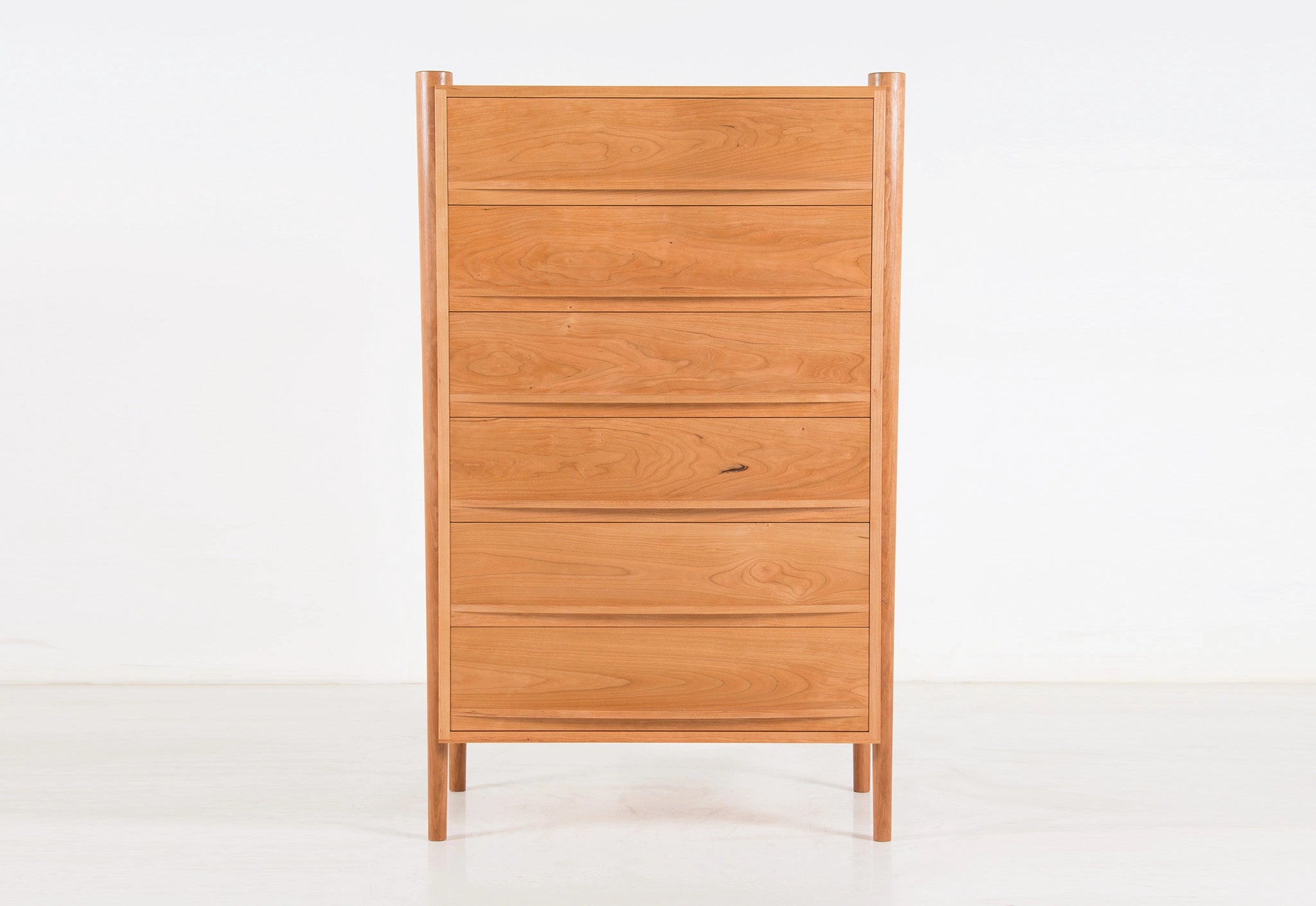 Wooden dresser with multiple drawers on a white background