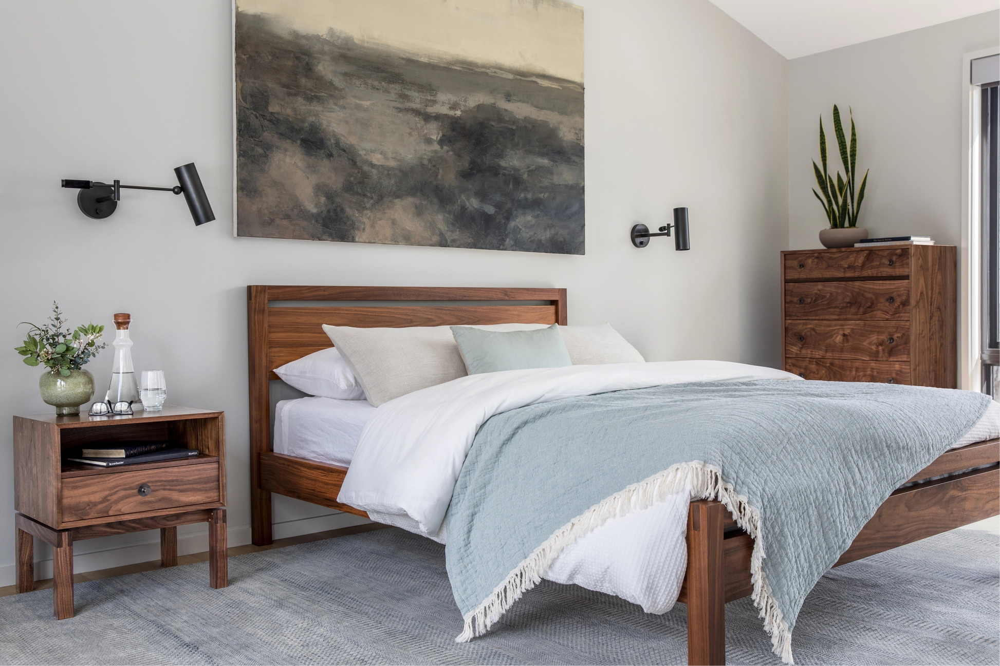 Bedroom with wooden bed, nightstands, and wall art