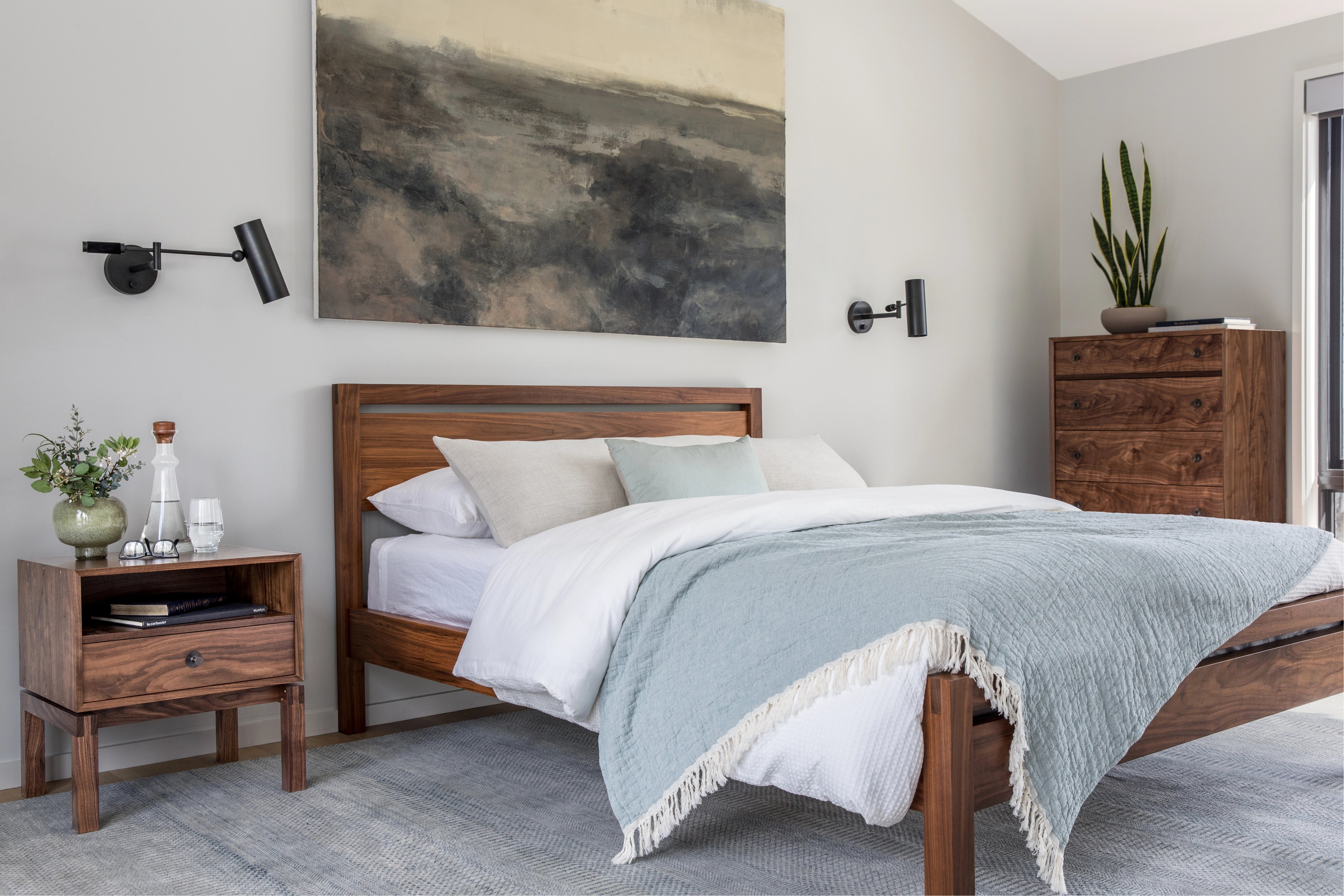 Bedroom with wooden bed, nightstands, and wall art