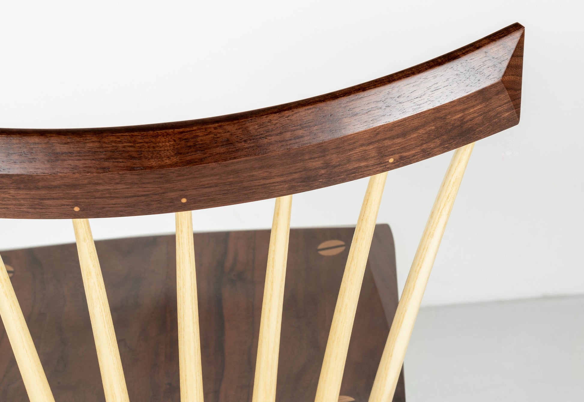 Wooden chair with curved backrest and straight legs on a white background