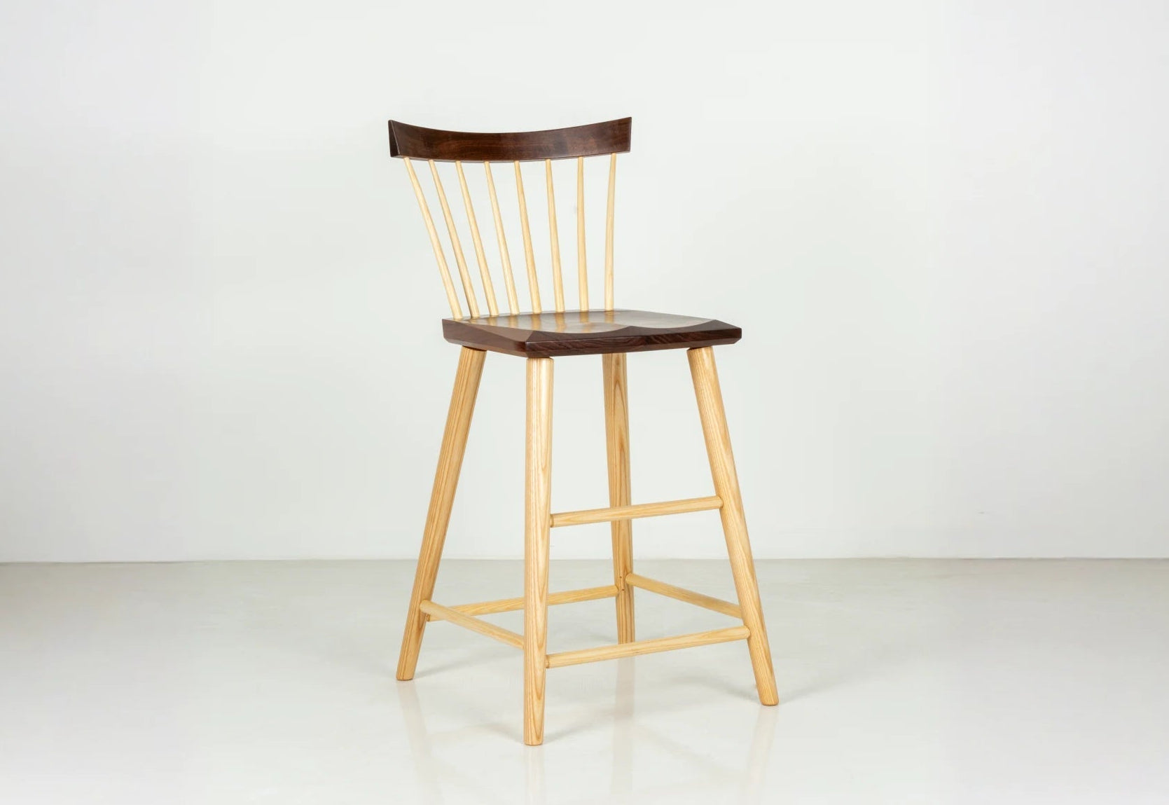 Wooden bar stool with a dark seat on a white background