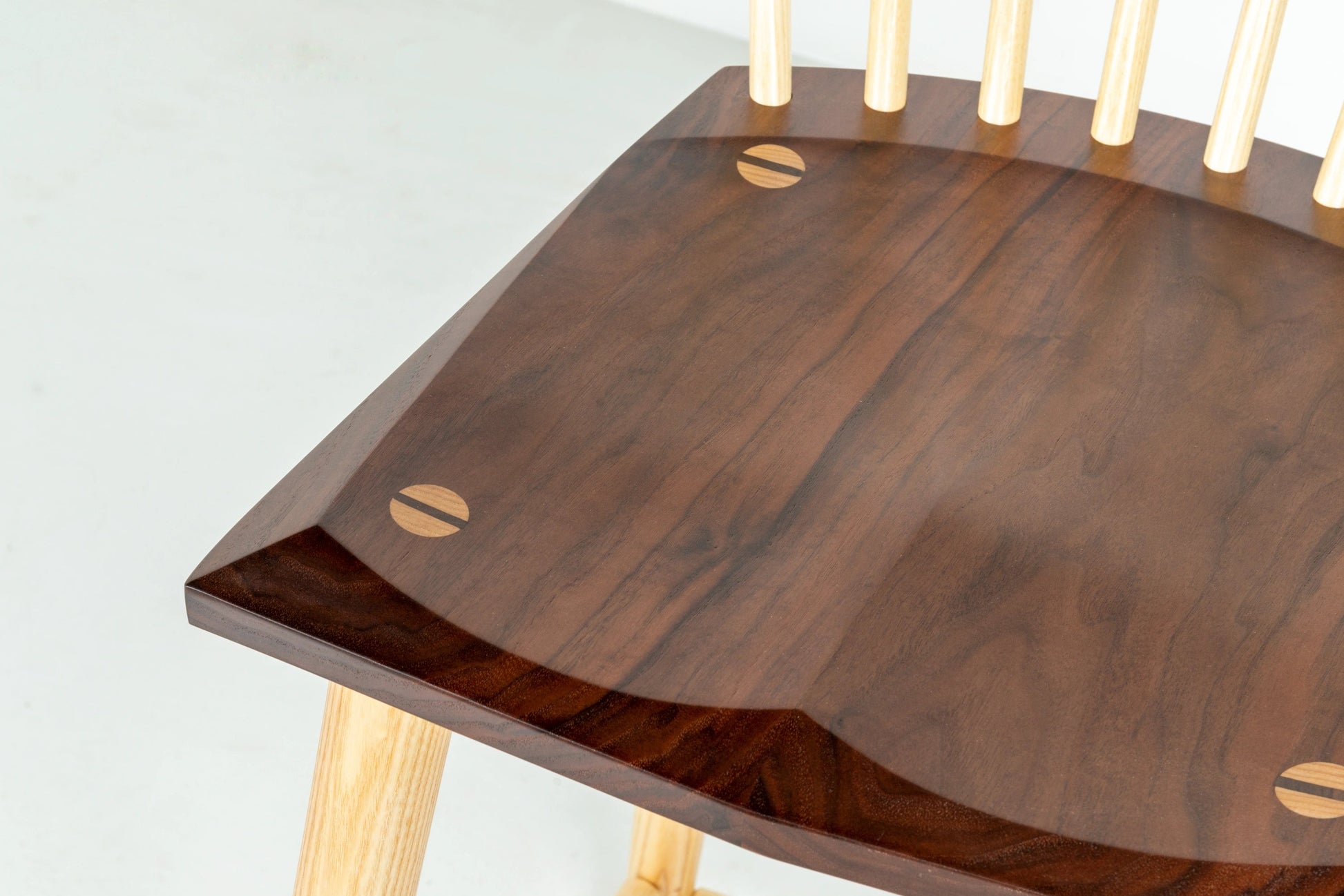 Wooden table with a dark brown surface and light wood legs on a white background