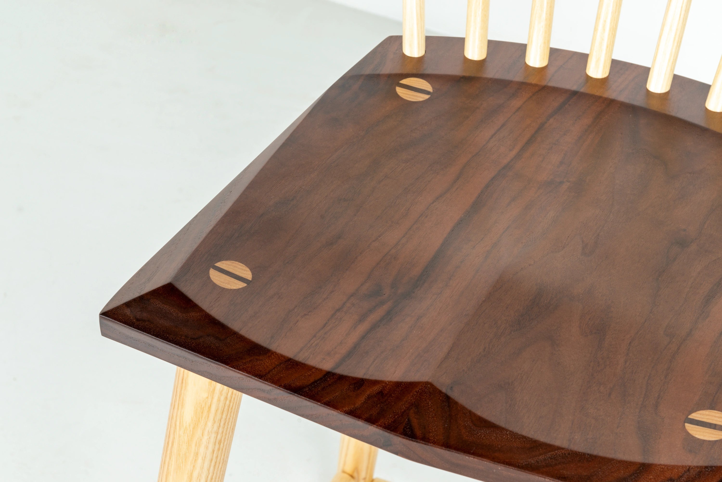 Wooden table with a dark brown surface and light wood legs on a white background