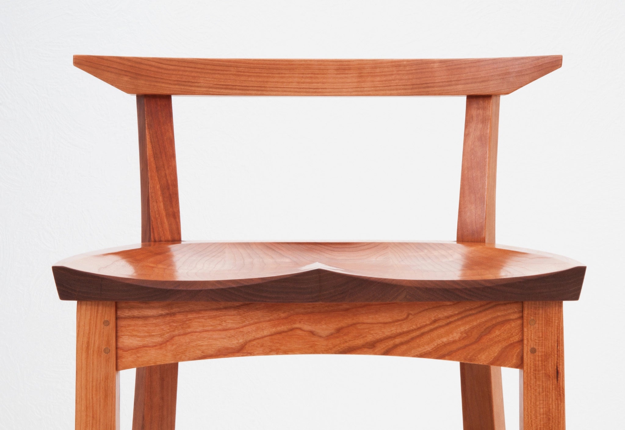 Wooden chair with a curved backrest and seat on a white background