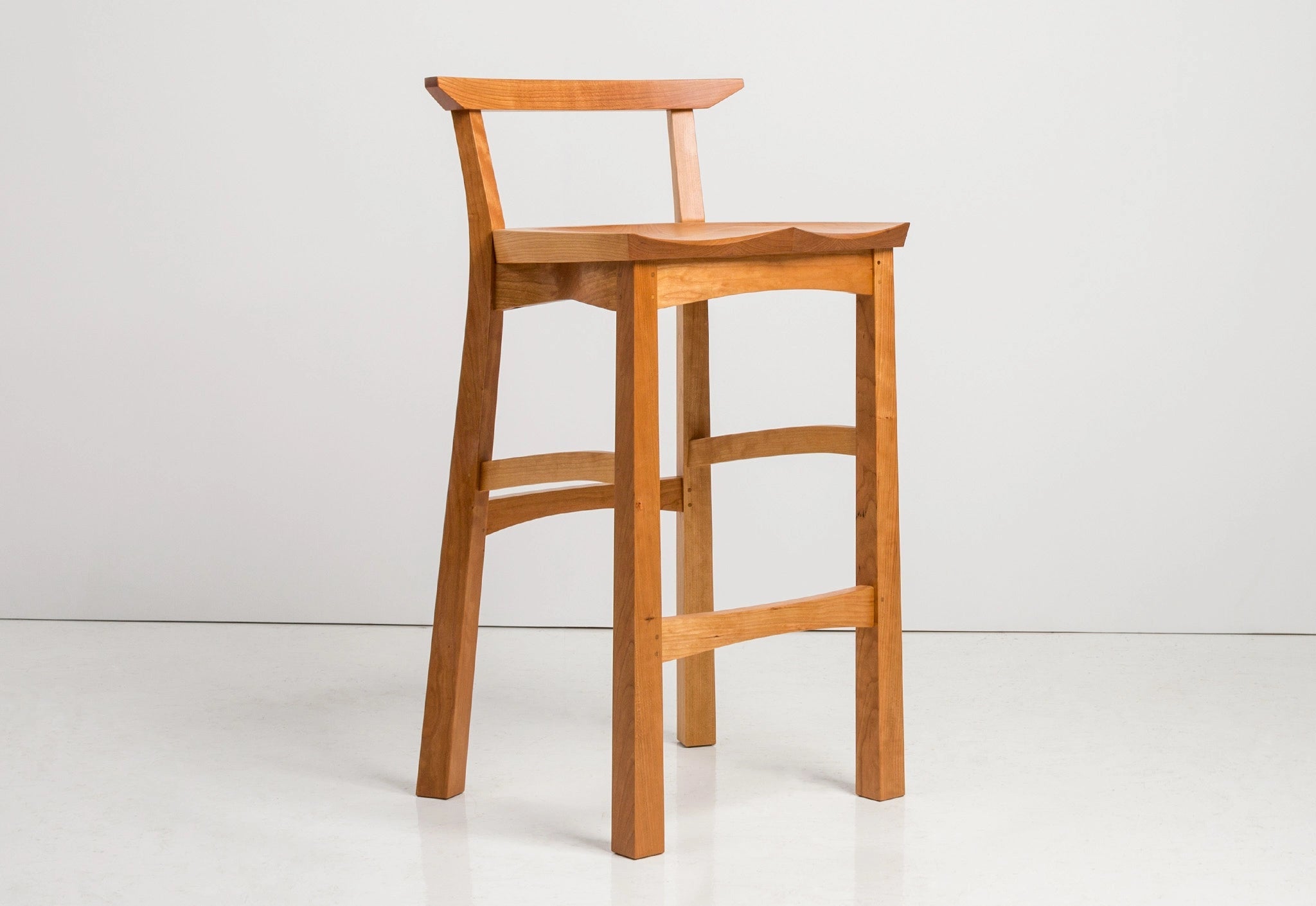 Wooden bar stool on a white background