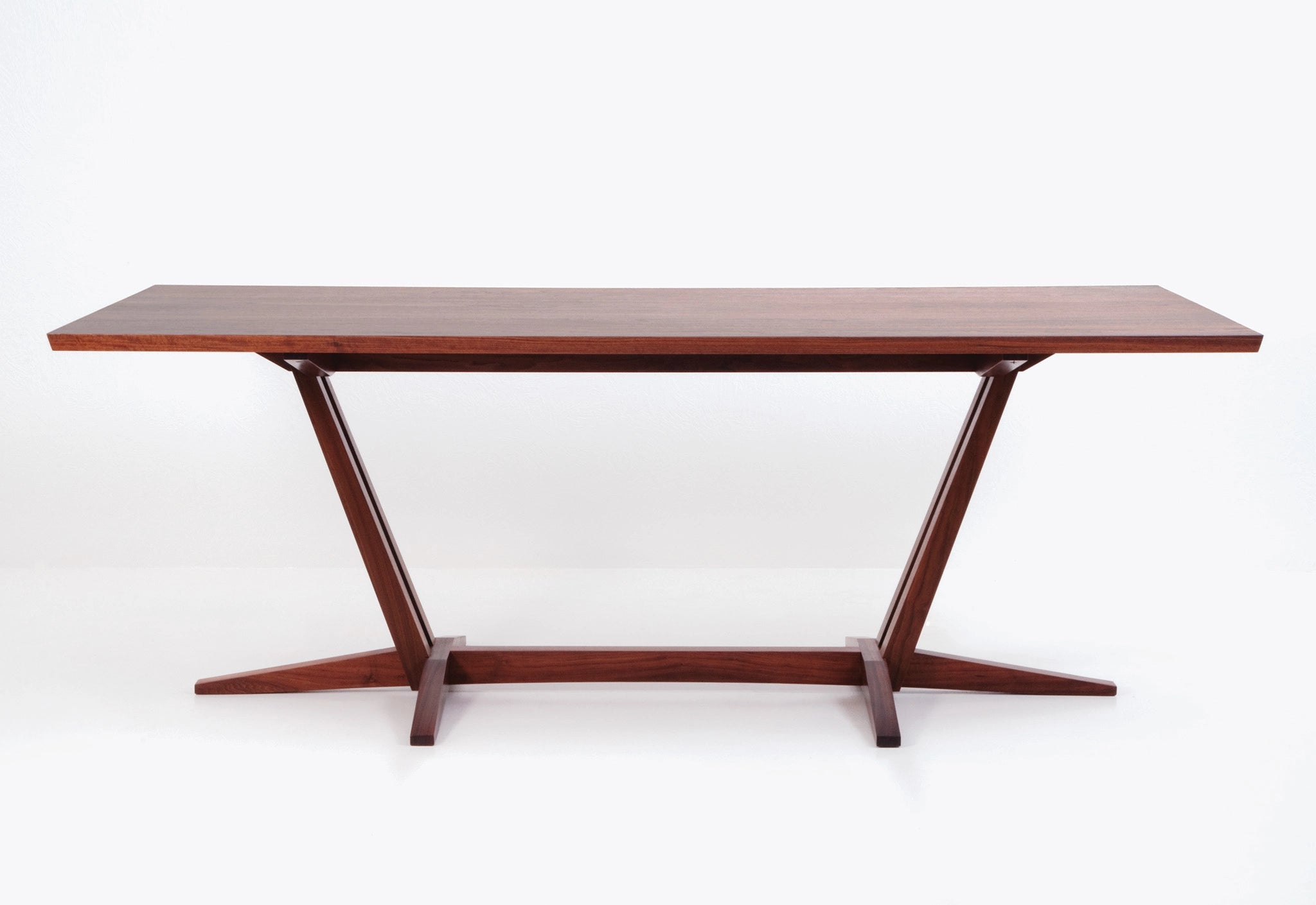 Wooden dining table with a minimalist design on a white background