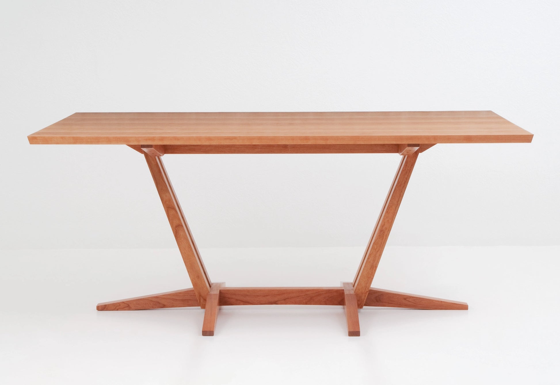 Wooden table with a minimalist design on a white background