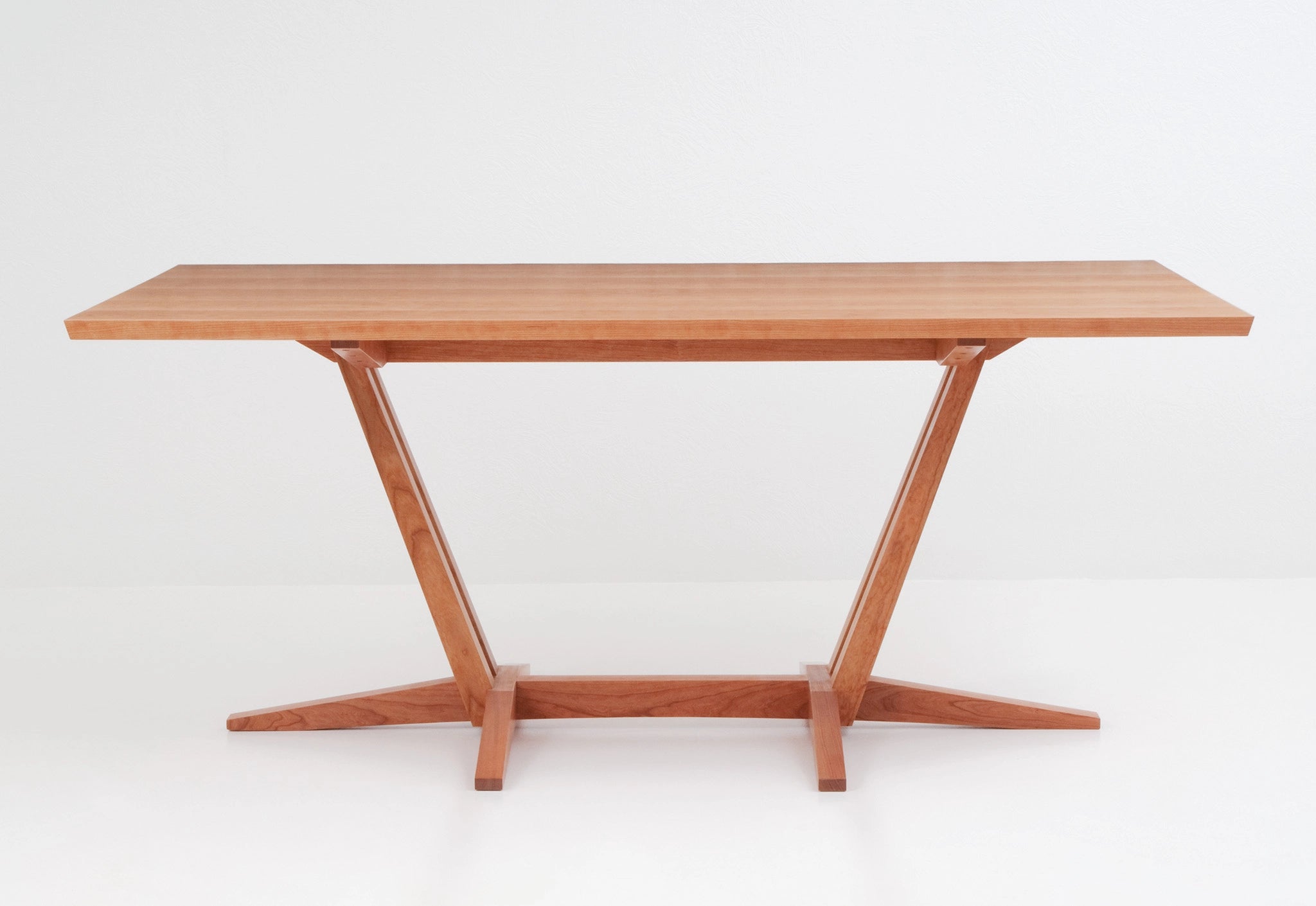 Wooden table with a minimalist design on a white background