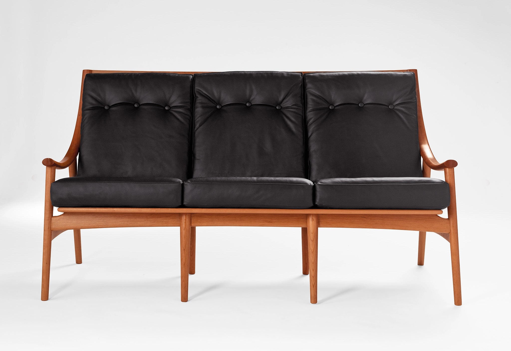 Sofa with black leather on a white background.