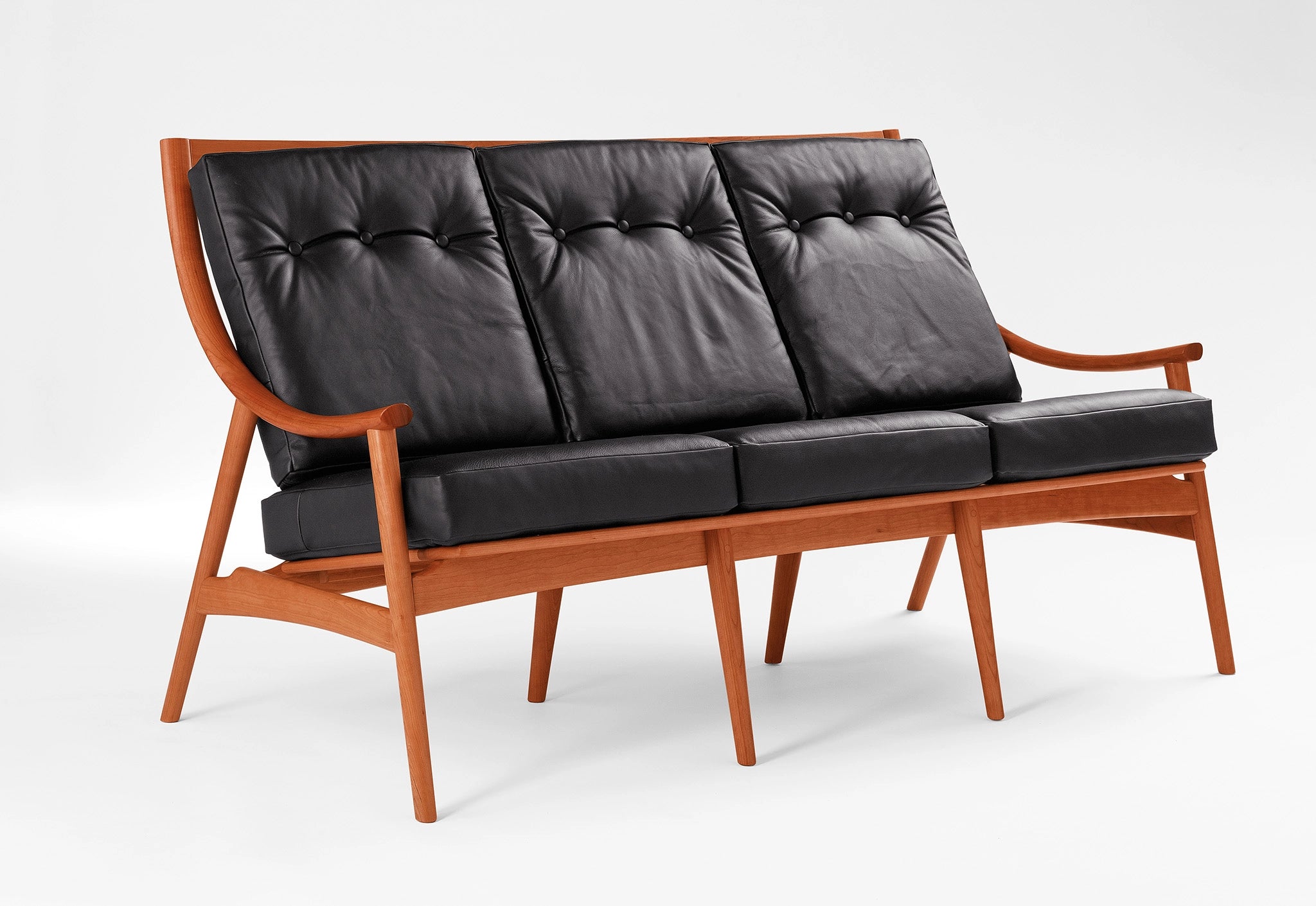 Sofa with black leather on a white background.