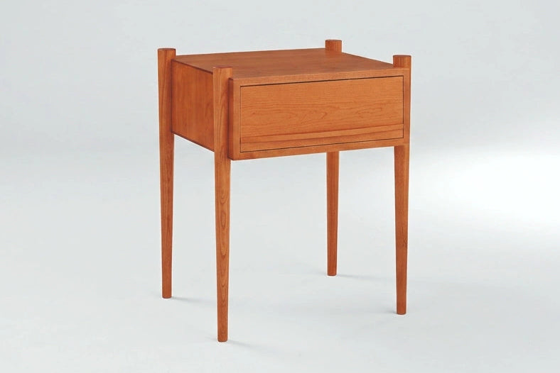 Wooden nightstand with a drawer on a white background