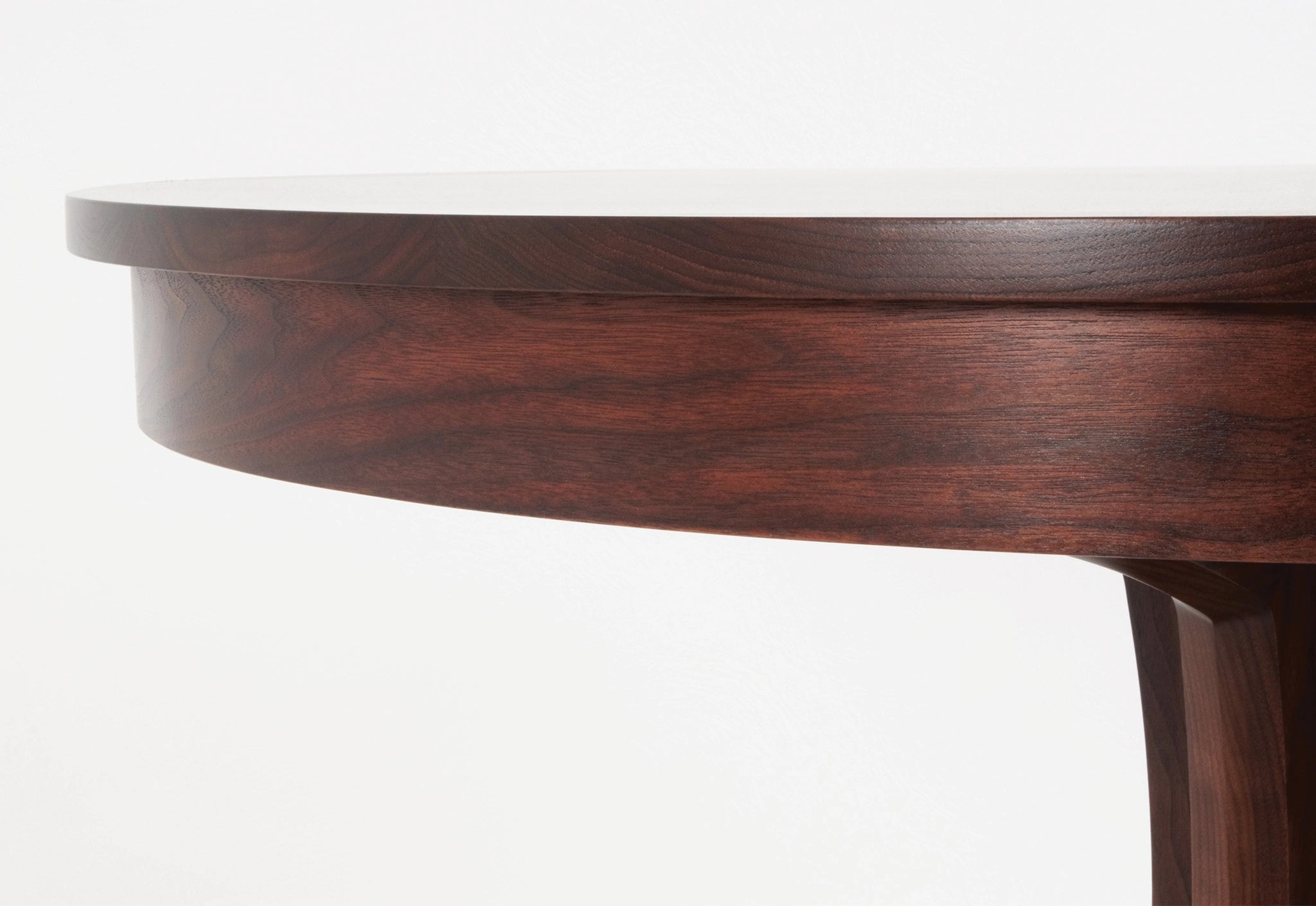 Close-up of a wooden table with a white top on a white background