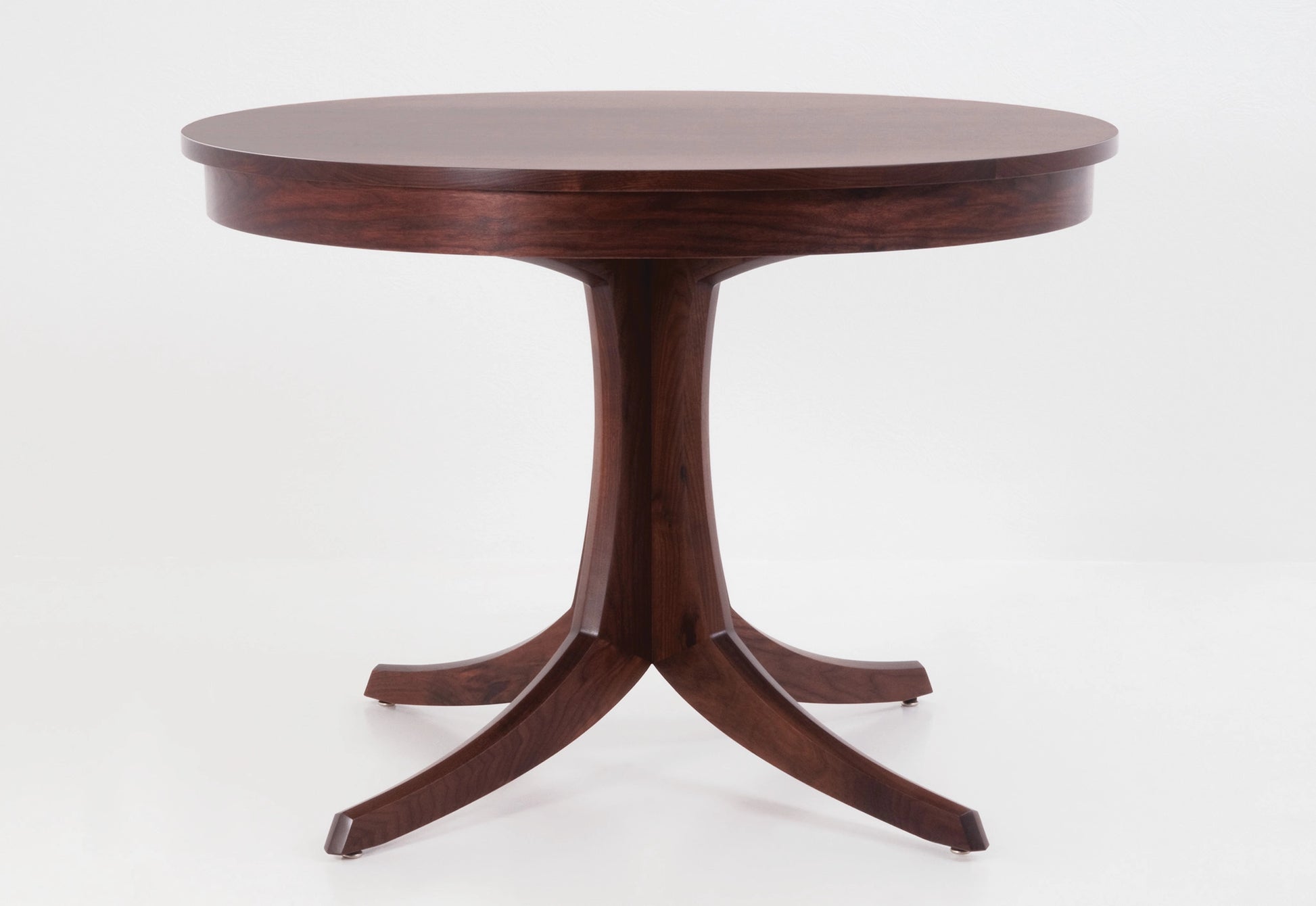 Wooden round table with a pedestal base on a white background