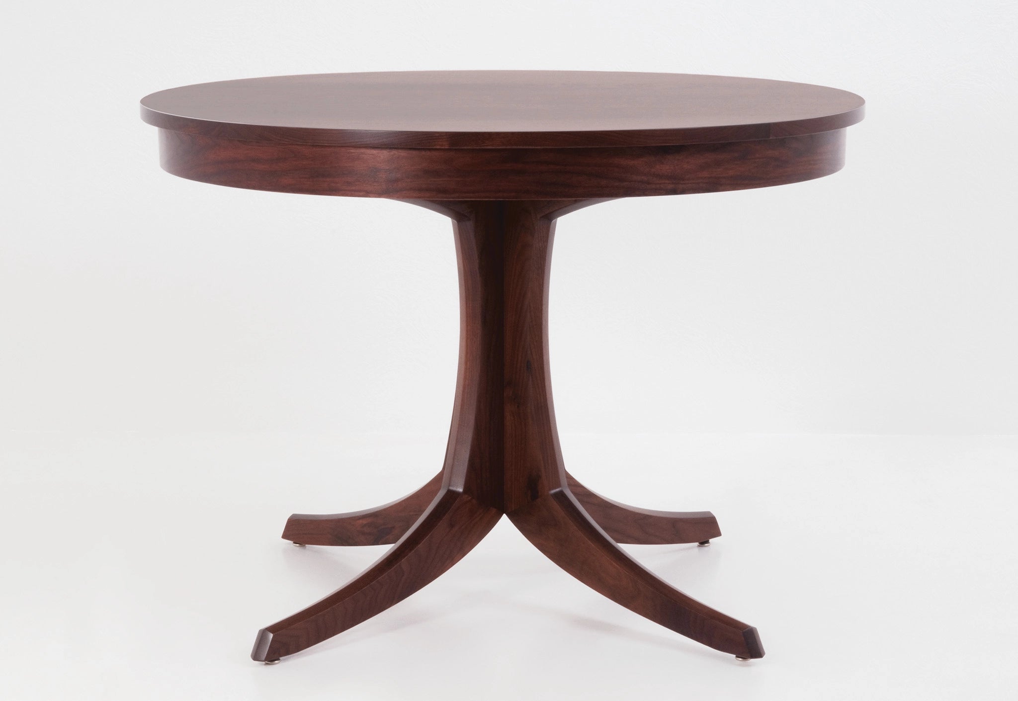 Wooden round table with a pedestal base on a white background