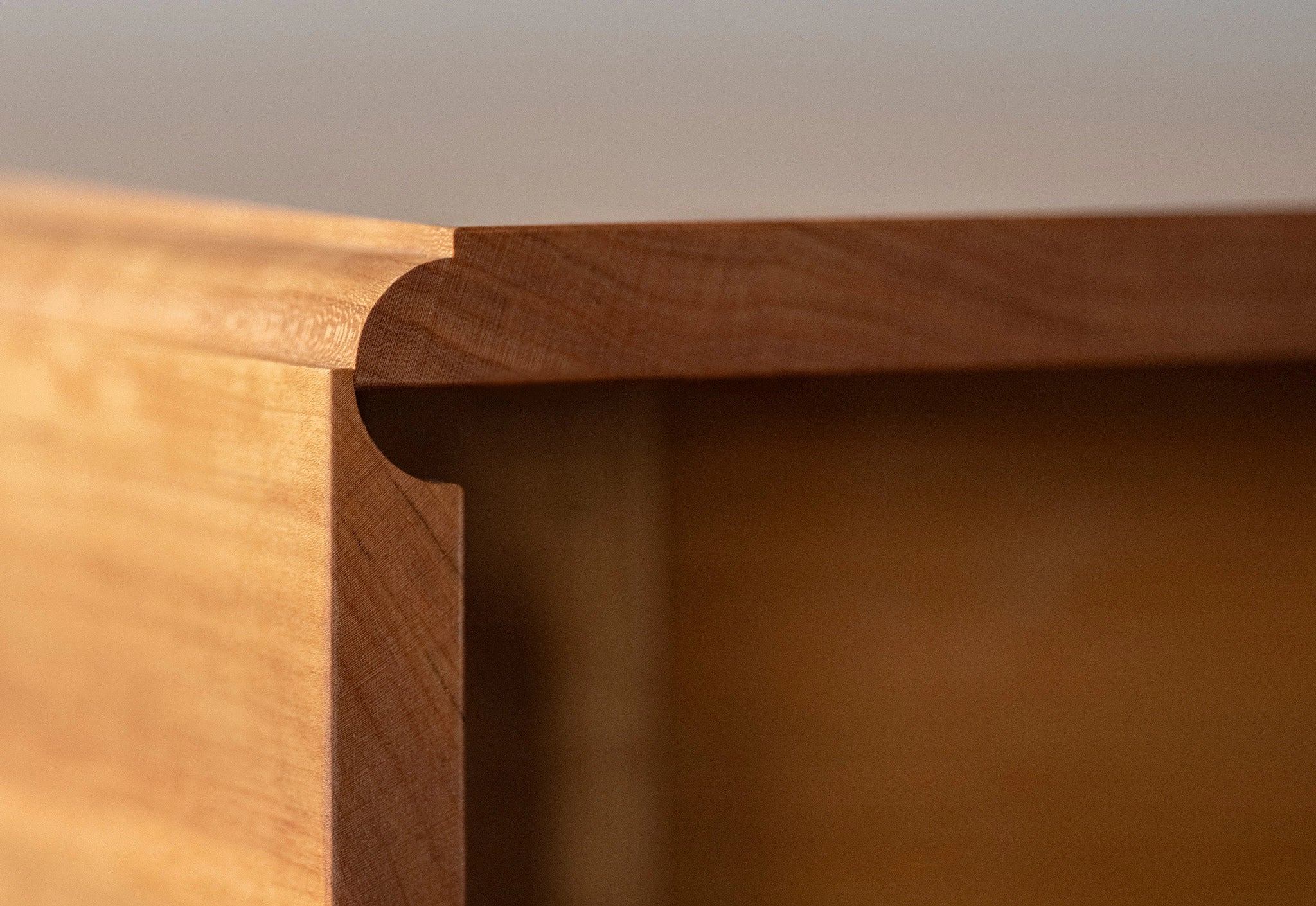 Close-up of a wooden furniture corner with a smooth finish.