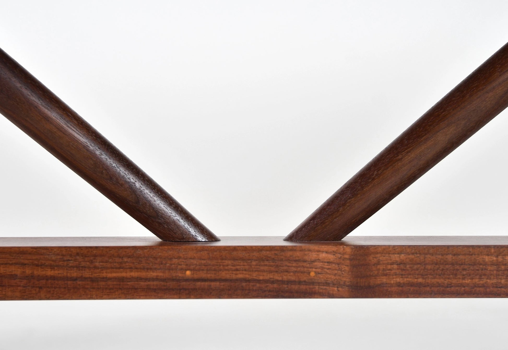 Close-up of a wooden shelf with a white background