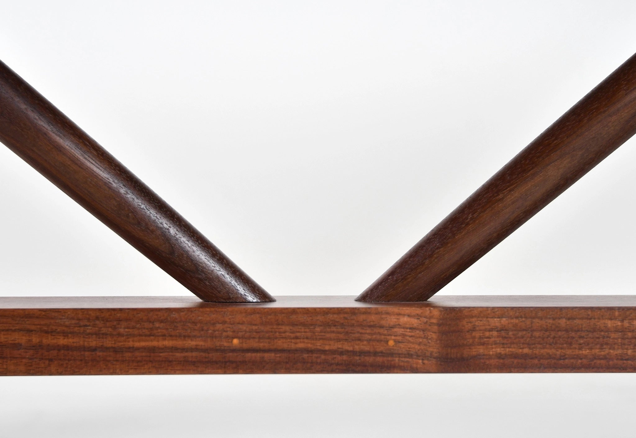 Close-up of a wooden shelf with a white background