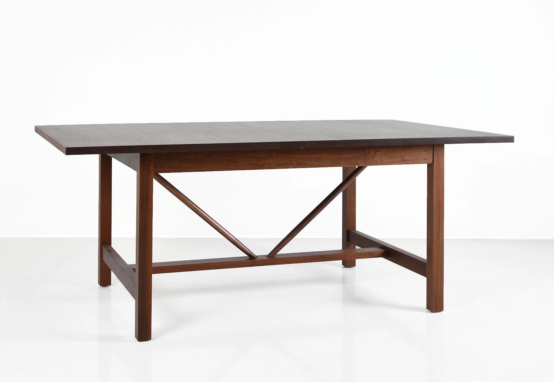 Wooden dining table with a gray top on a white background