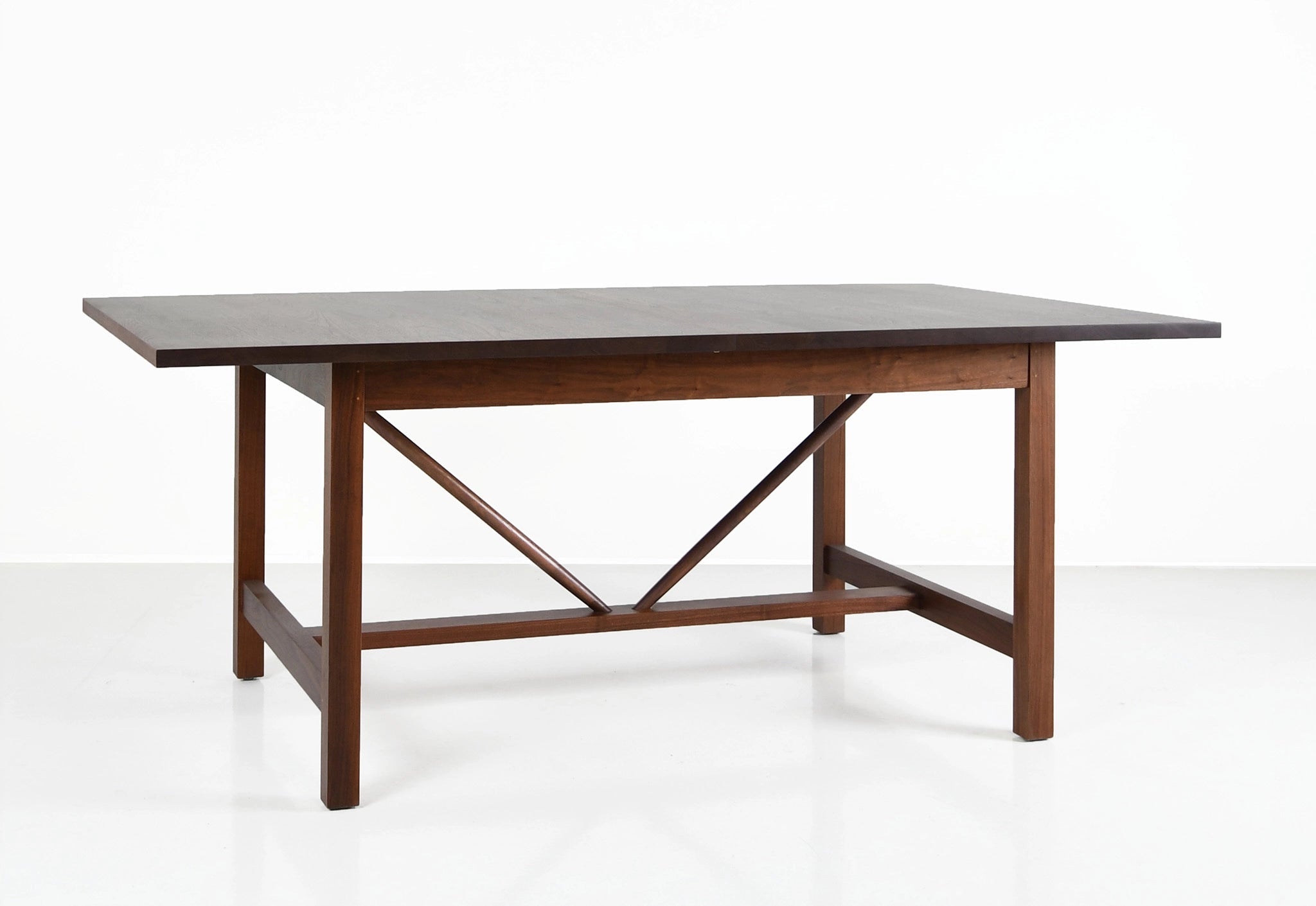 Wooden dining table with a gray top on a white background