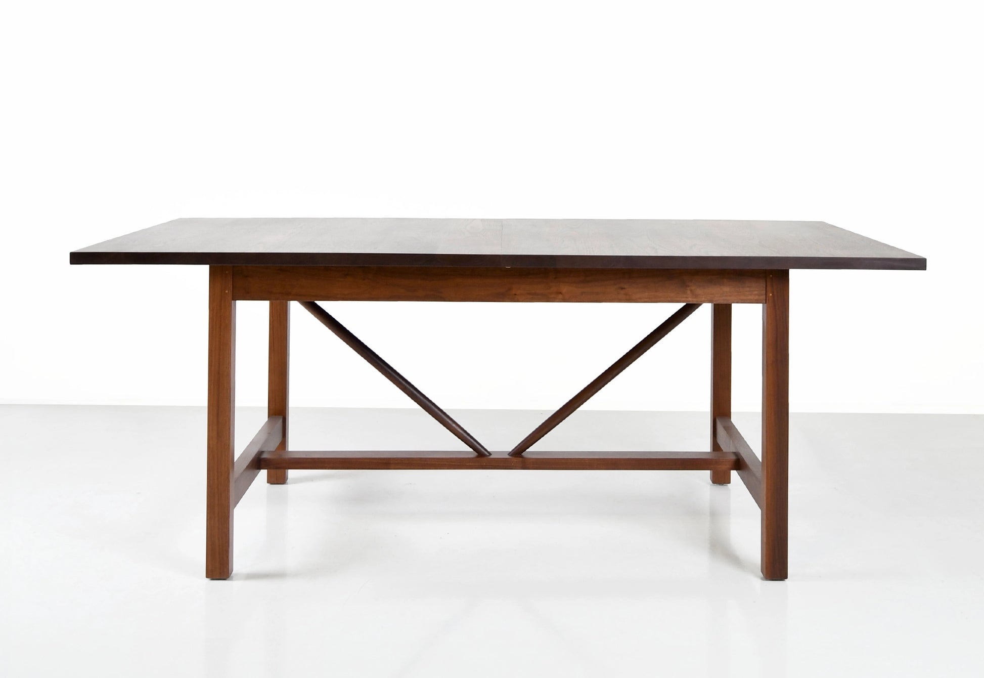 Wooden dining table with a white marble top on a white background