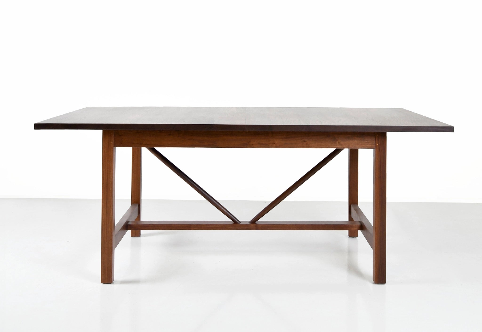 Wooden dining table with a white marble top on a white background