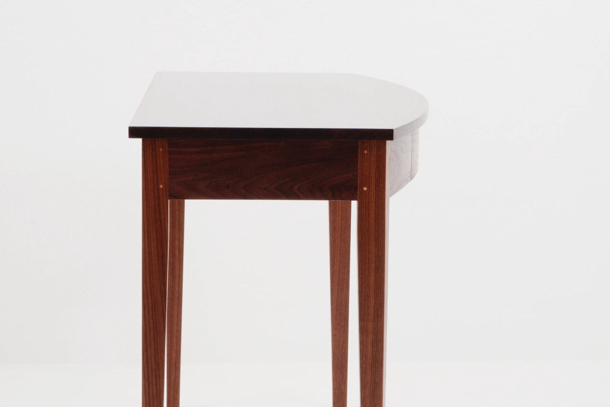 Wooden side table with white marble top on a white background