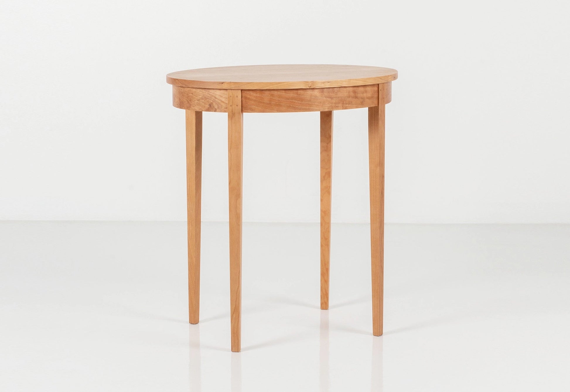 Small cherry wood table on a white background.