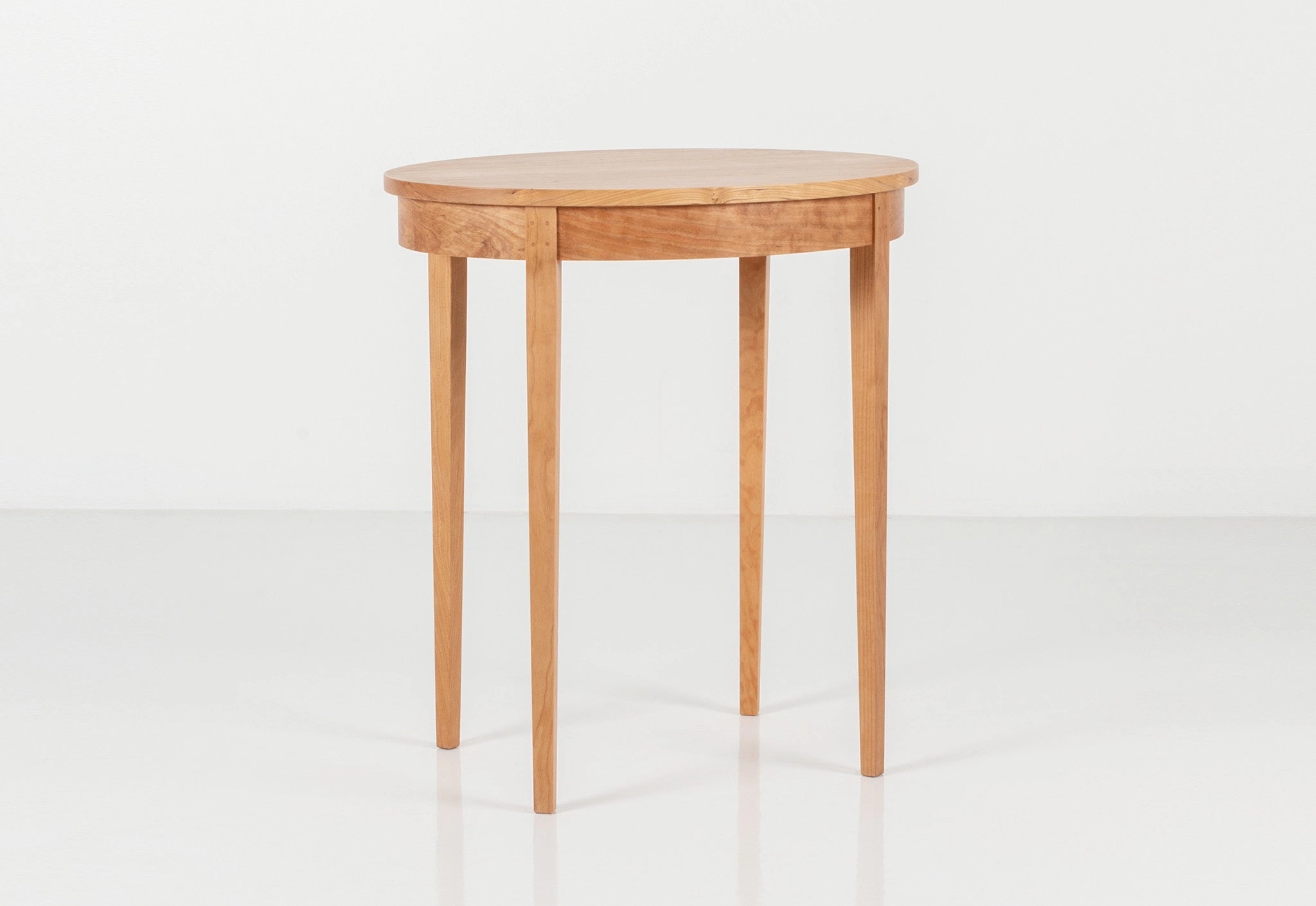 Small cherry wood table on a white background.