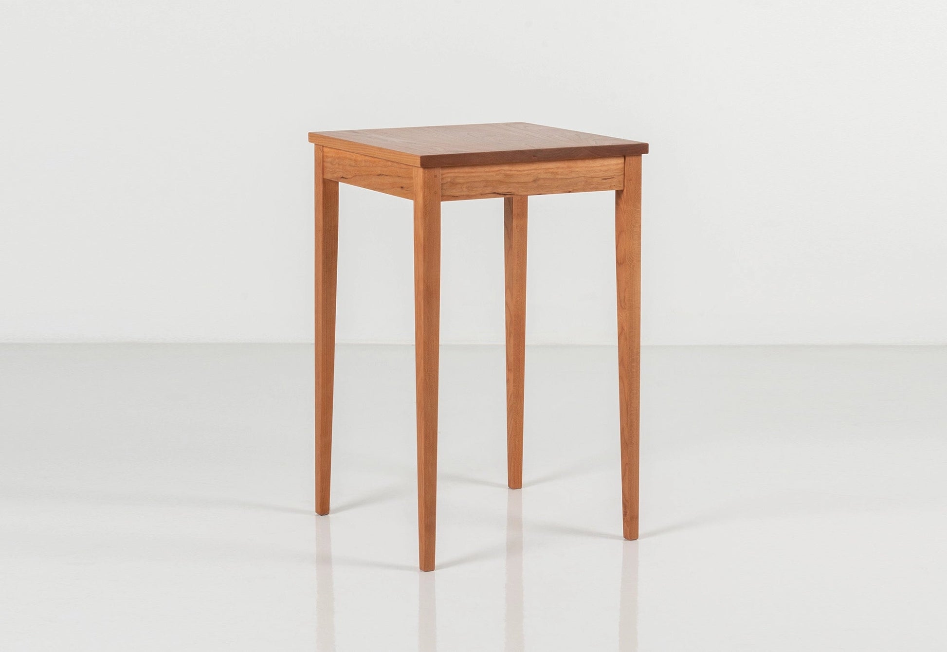 Wooden side table on a white background