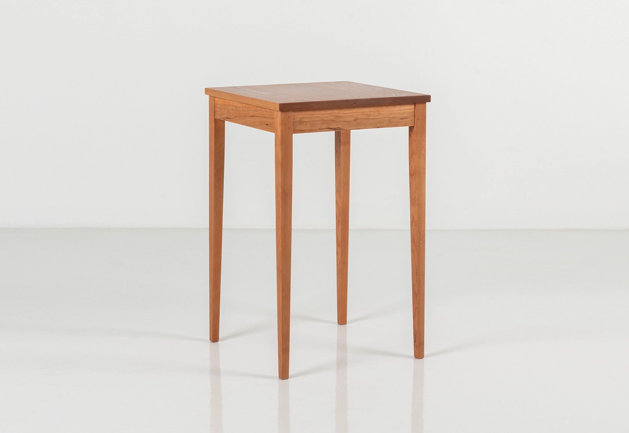 Wooden side table on a white background