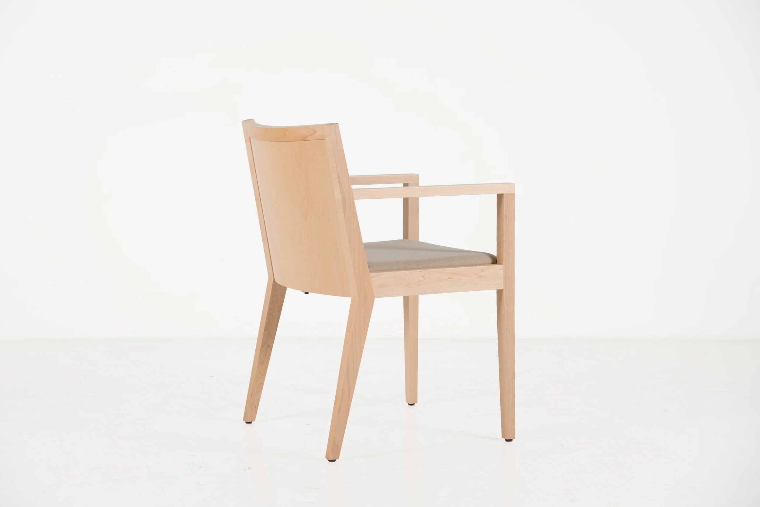 Wooden chair with a light gray cushion on a white background