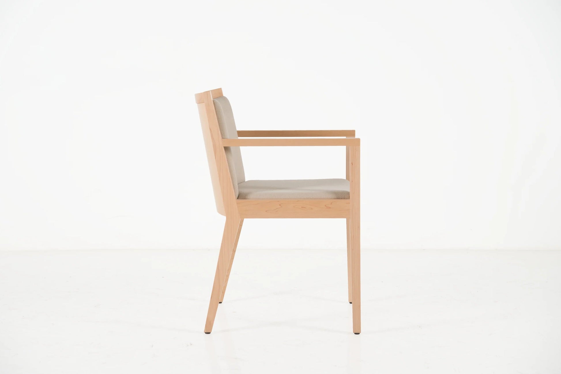 Wooden chair with beige cushion on a white background