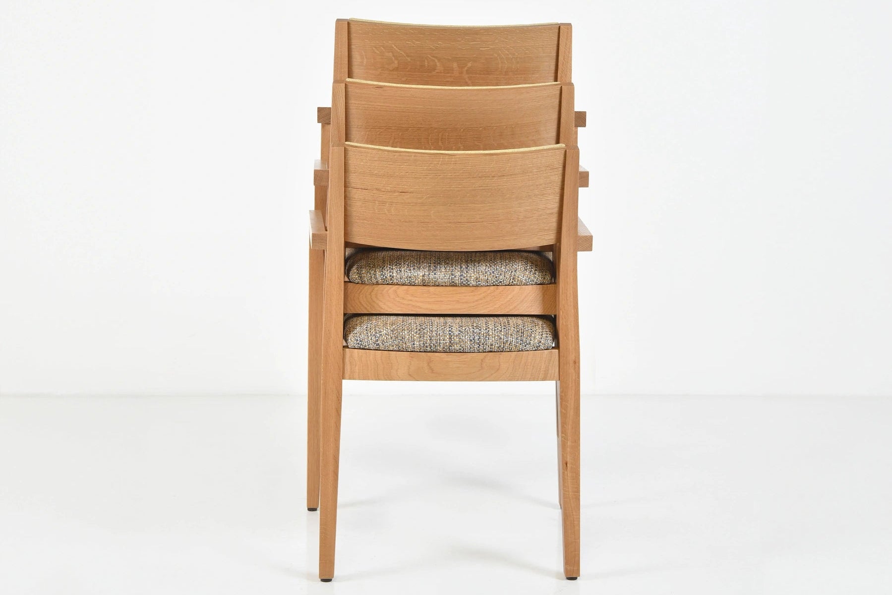 Wooden chair with a gray cushion on a white background