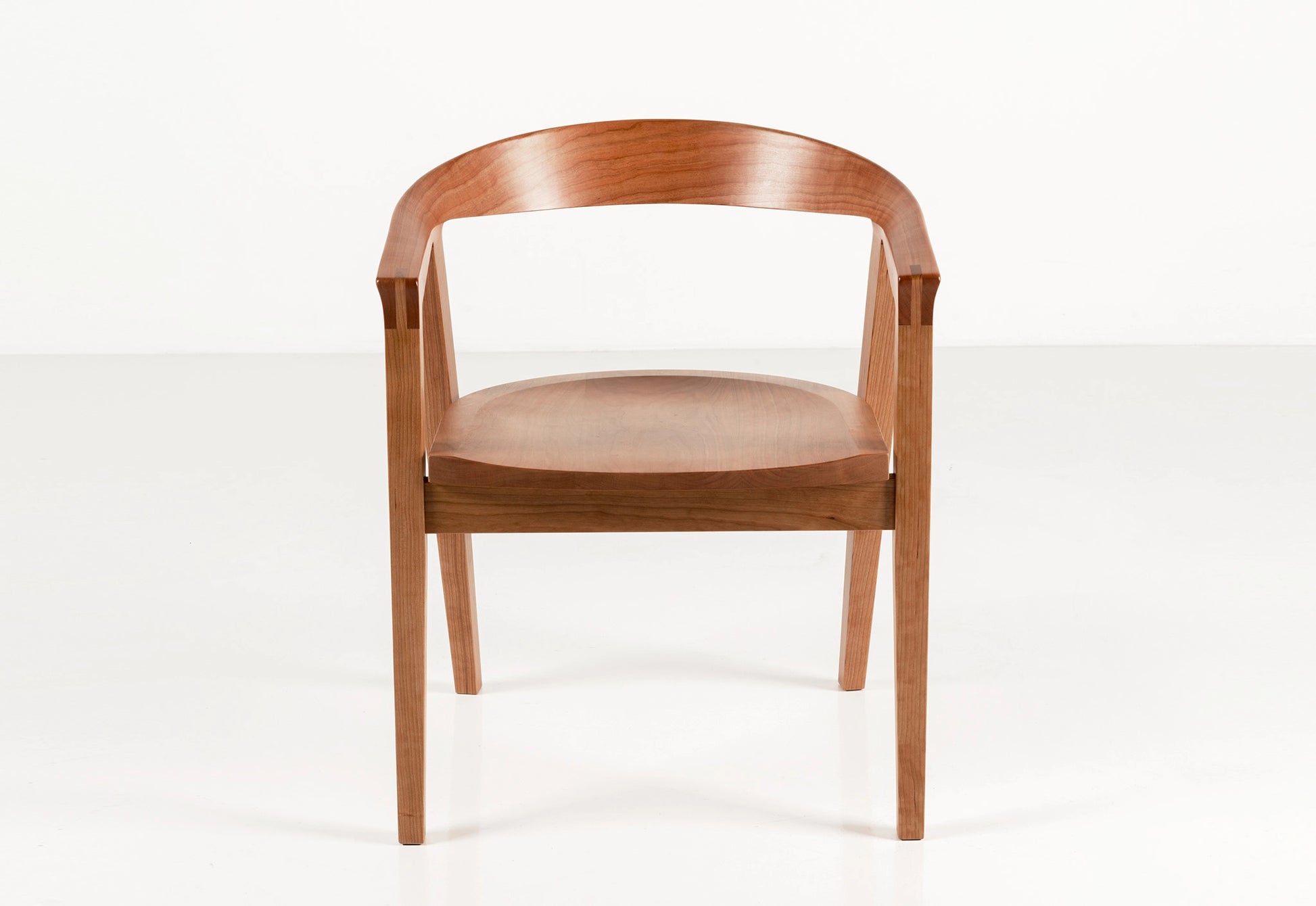 Wooden chair with a curved backrest on a white background