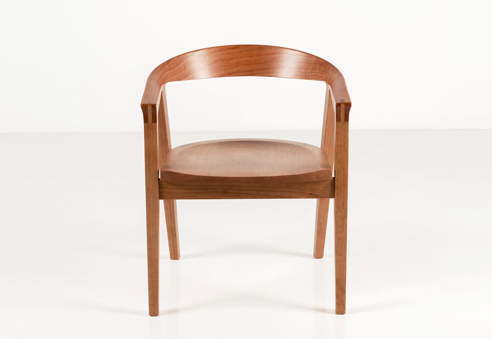 Wooden chair with a curved backrest on a white background
