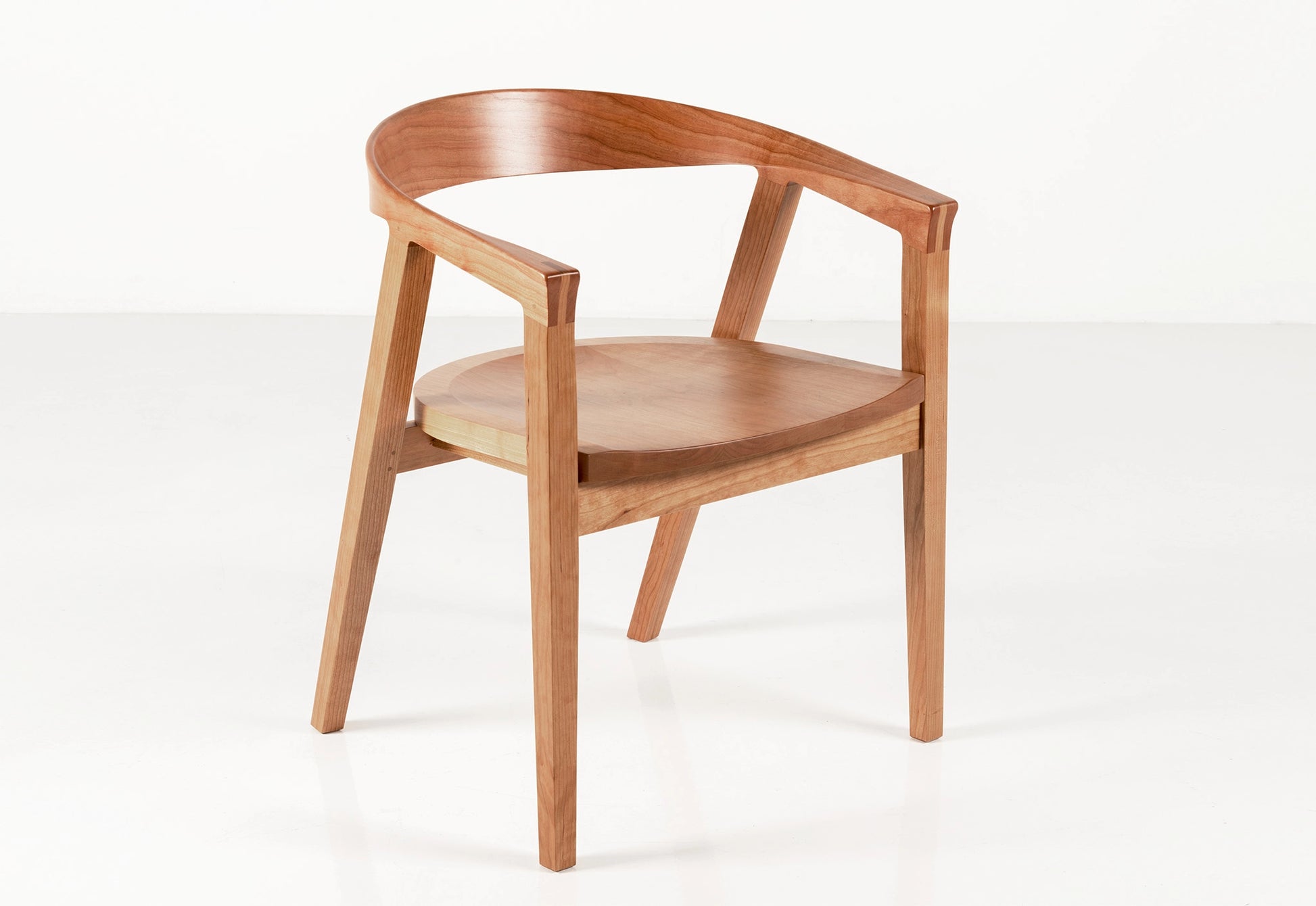 Wooden chair with curved armrests on a white background