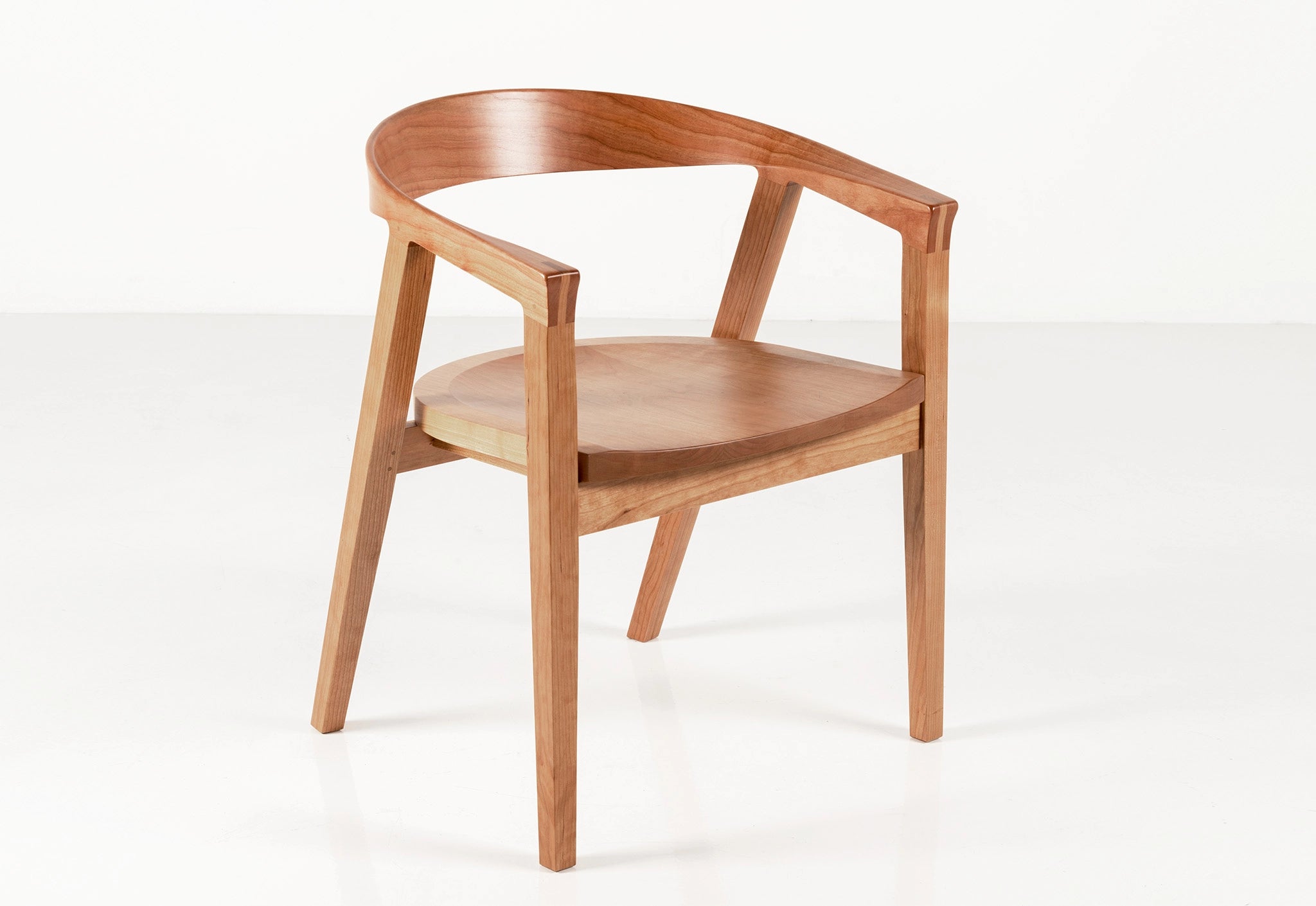 Wooden chair with curved armrests on a white background