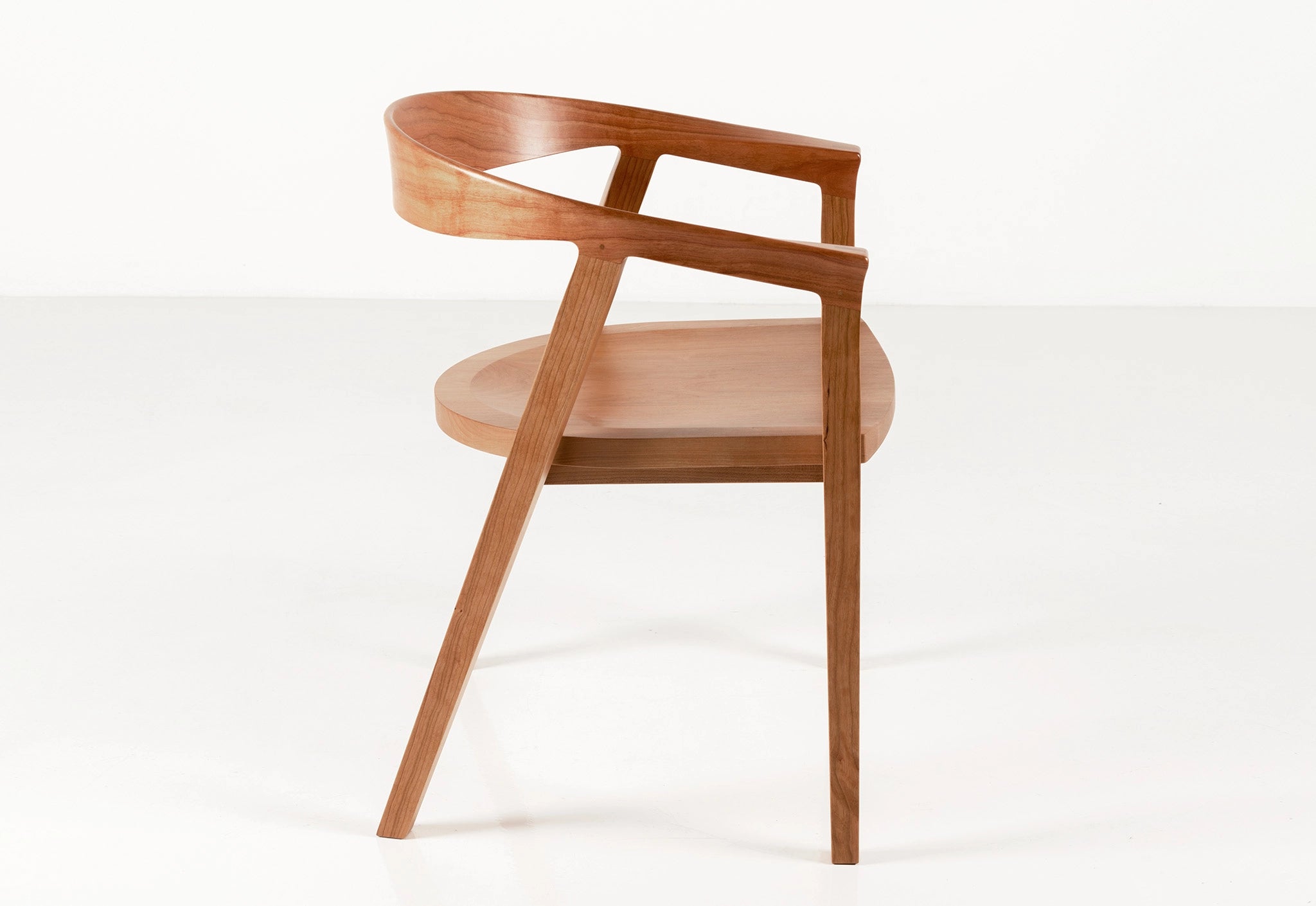 Wooden chair with a curved backrest on a white background