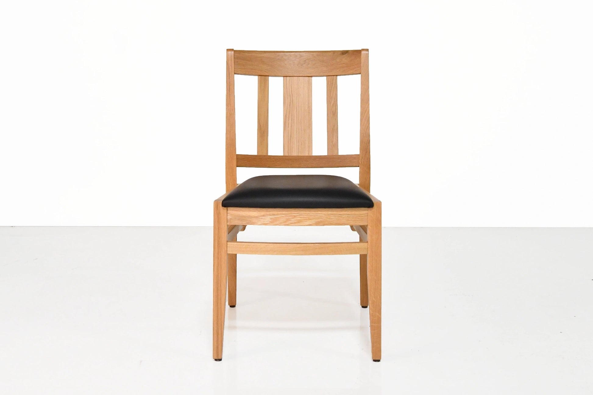 Wooden chair with black seat on a white background