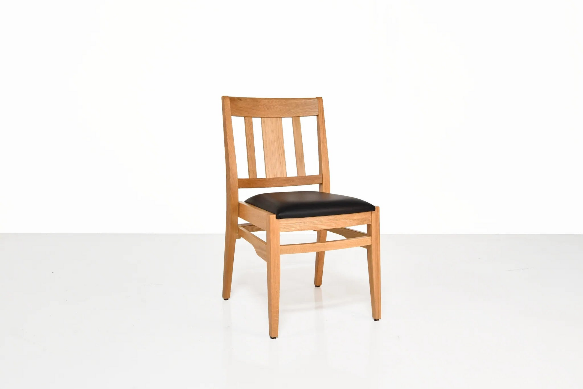 Wooden chair with a black seat on a white background