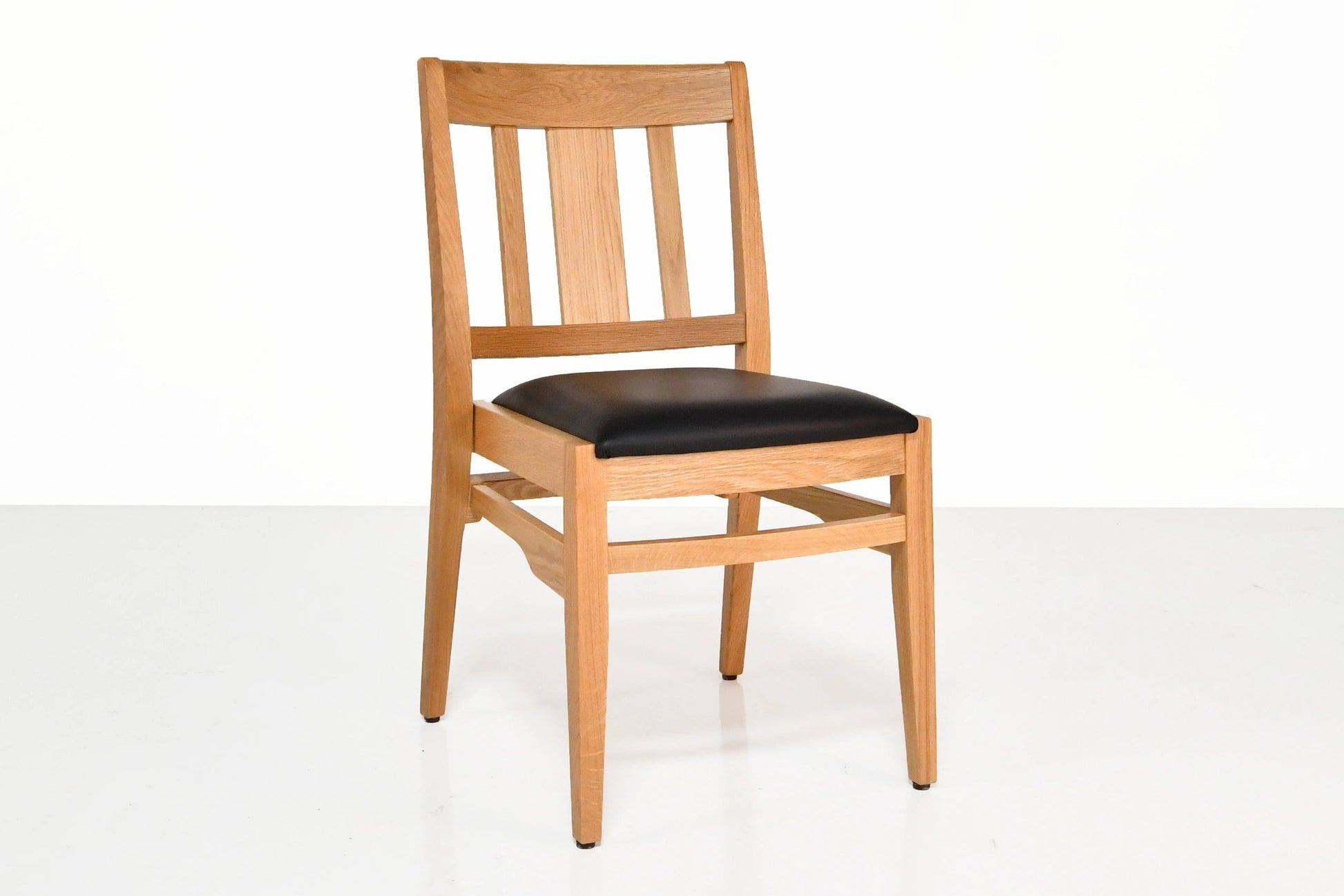 Wooden chair with a black seat on a white background
