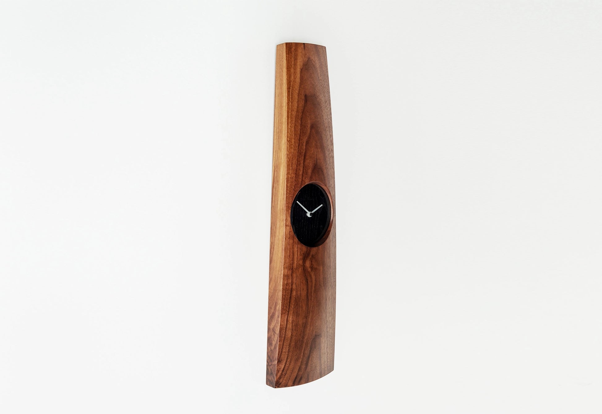 Wooden wall clock with a black clock face on a white background