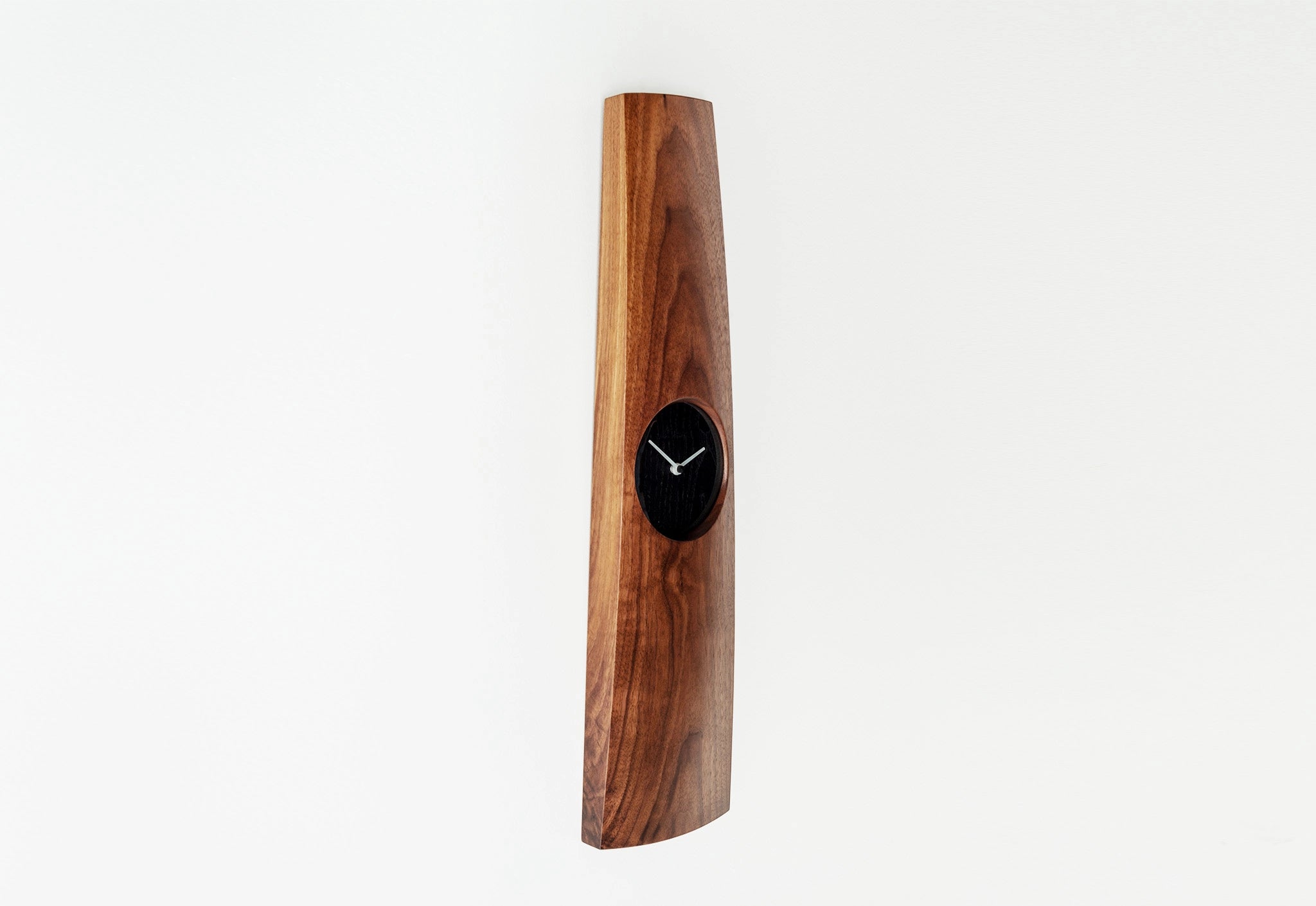 Wooden wall clock with a black clock face on a white background