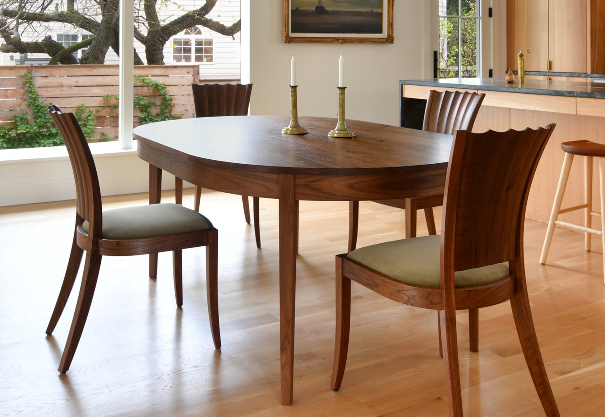 Wooden dining table with chairs in a well-lit room