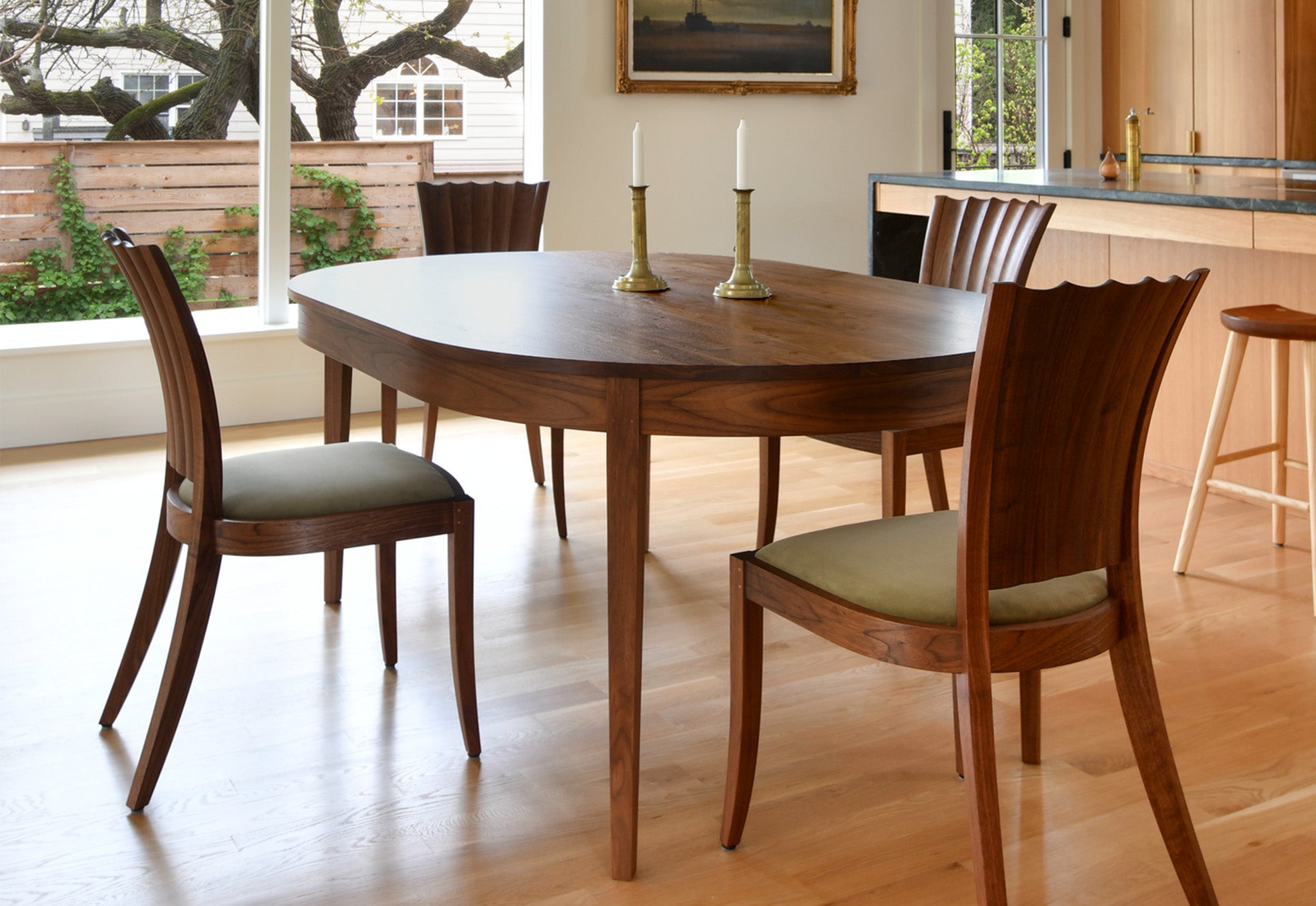 Wooden dining table with chairs in a well-lit room