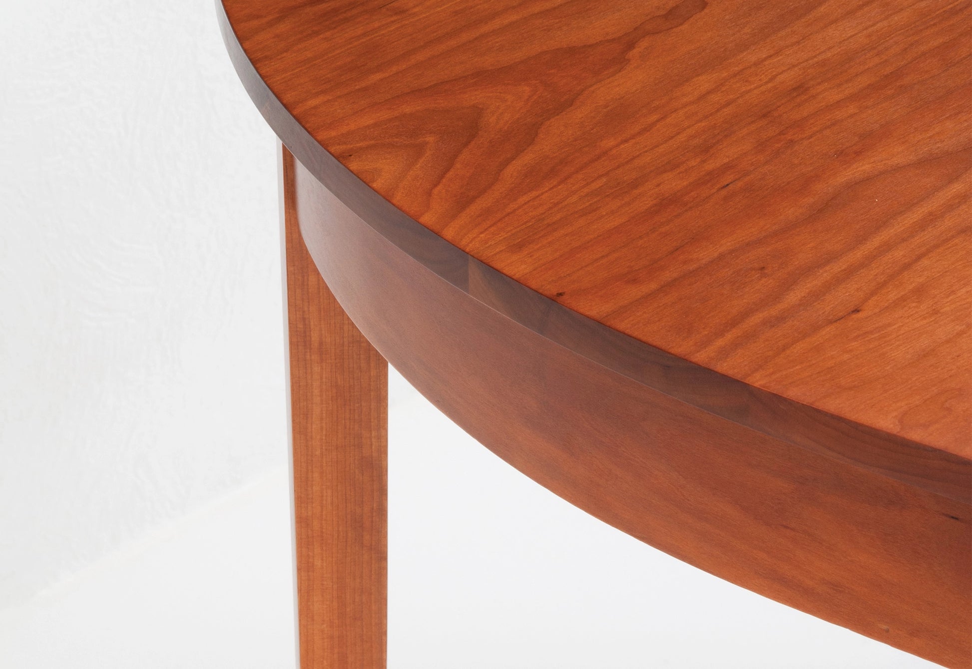 Close-up of a wooden table with a white background